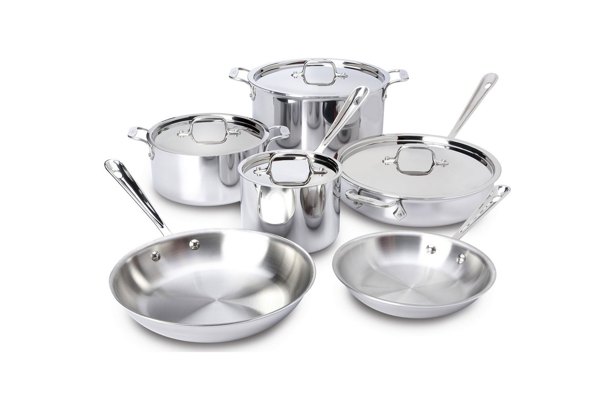 A set of shiny stainless steel cookware including two frying pans, three covered pots of different sizes, and one covered saucepan, all with metal handles, arranged on a white background.