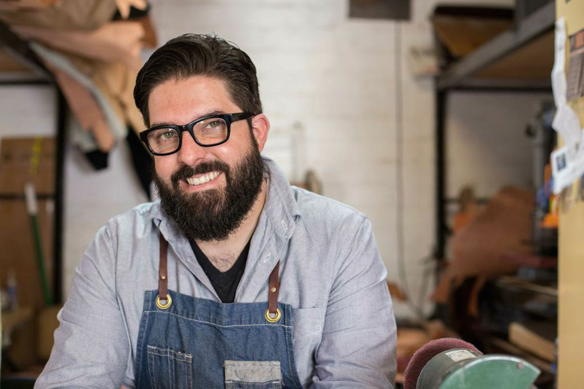 A man wearing glasses and a apron.
