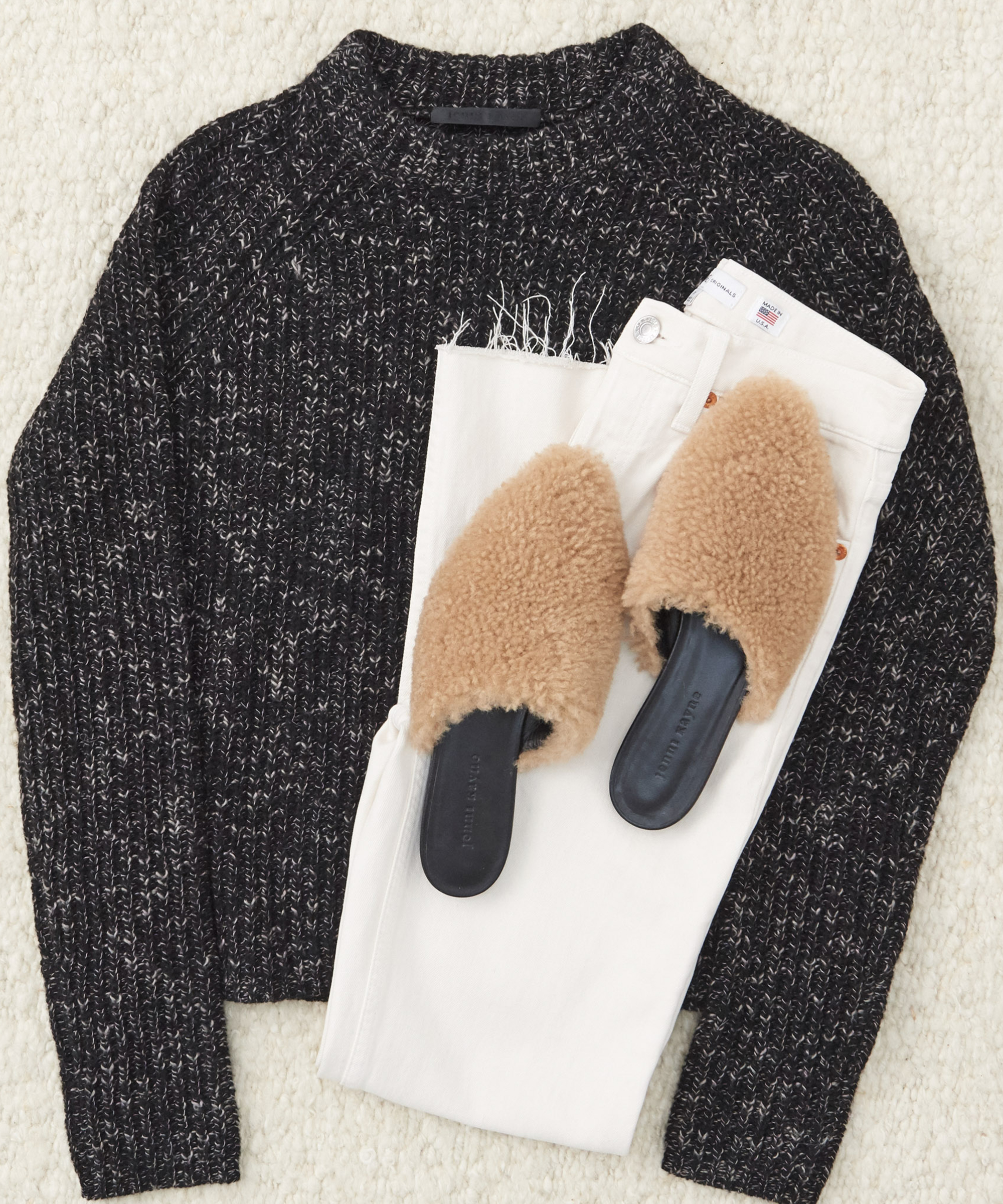 Jenni Kayne recycled cashmere fisherman with shearling mules and white jeans.