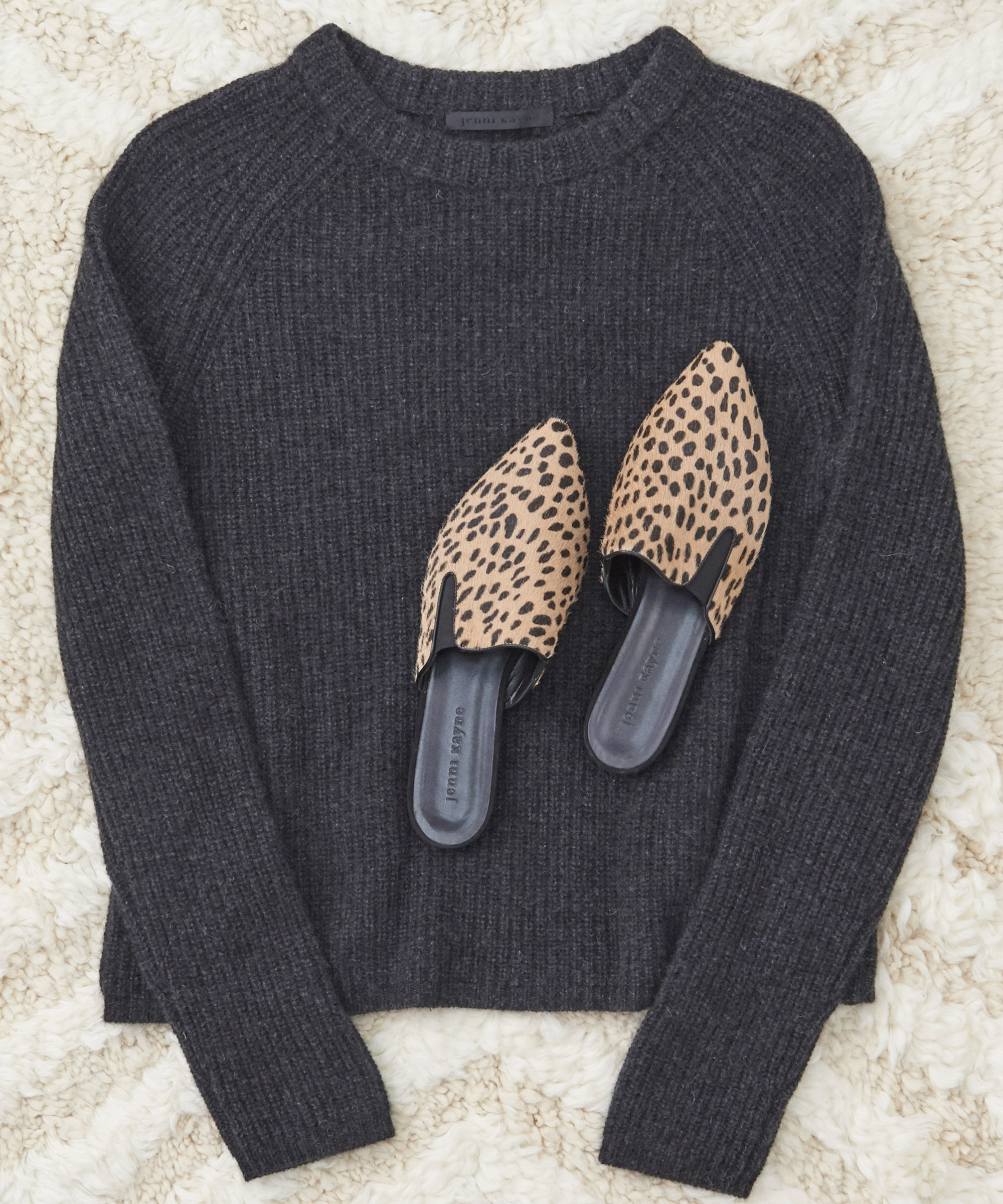 Overhead shot of jenni kayne cashmere fisherman sweater and cheetah pony hair mules.