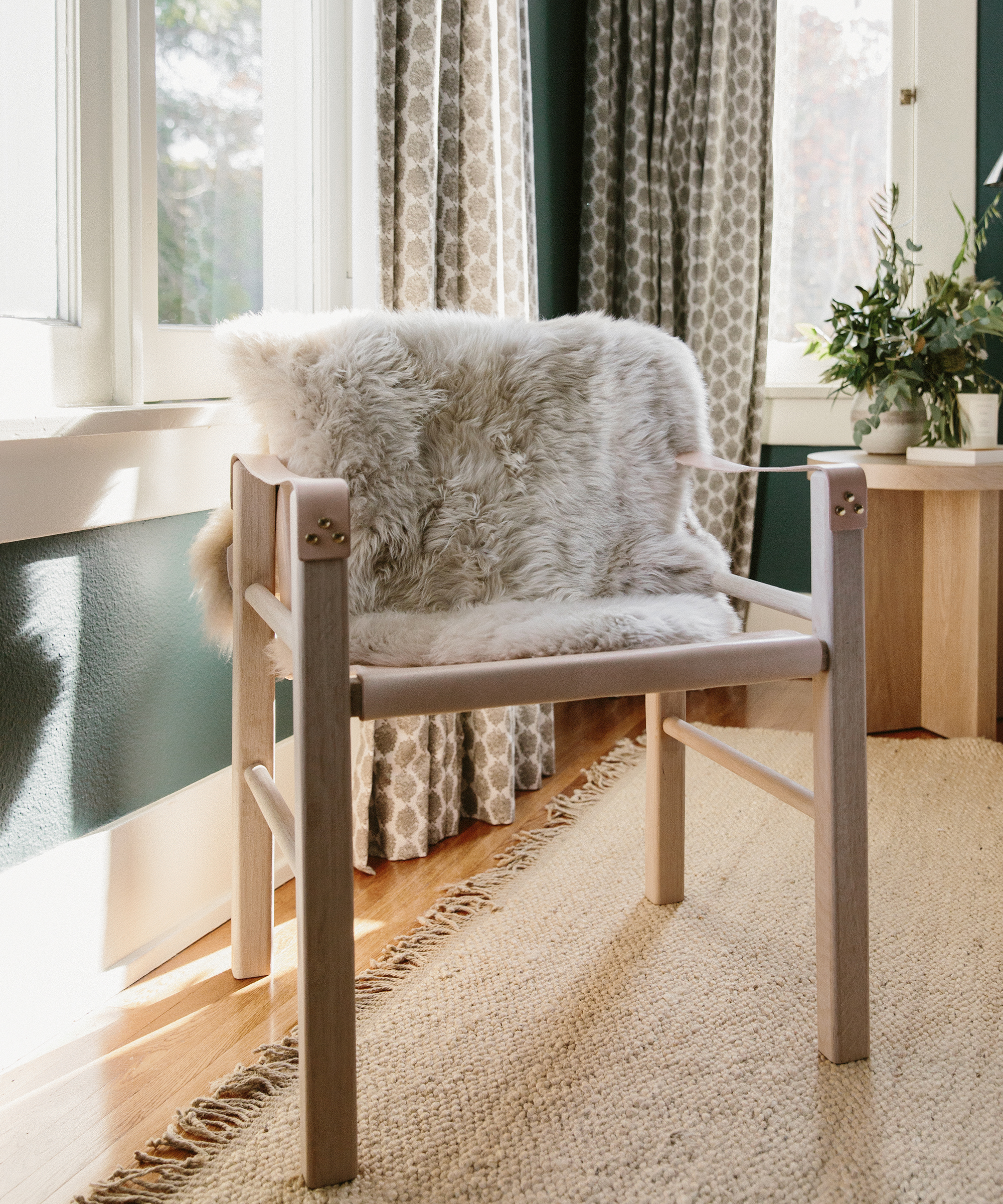 Jacey Duprie's bedroom with jenni kayne leather safari chair and sheepskin sitting on top of it.