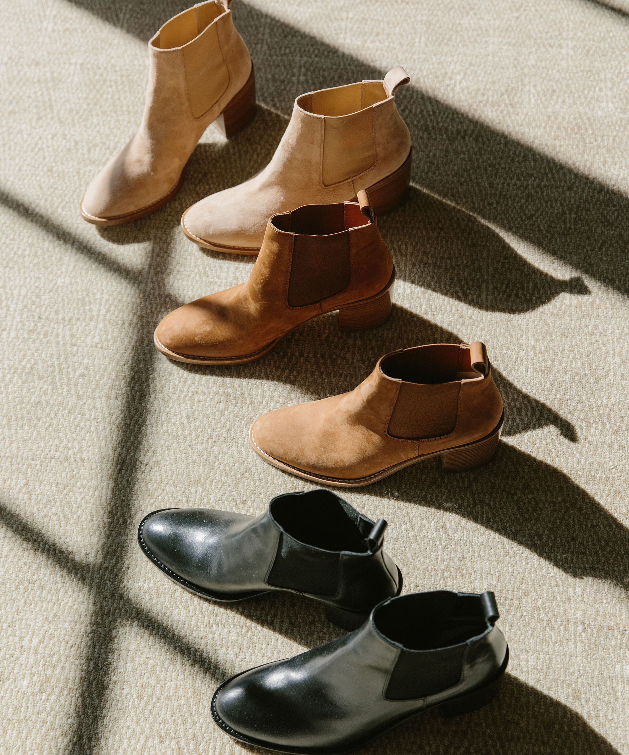 Three pairs of heeled Jenni Kayne Chelsea Boots on the ground.