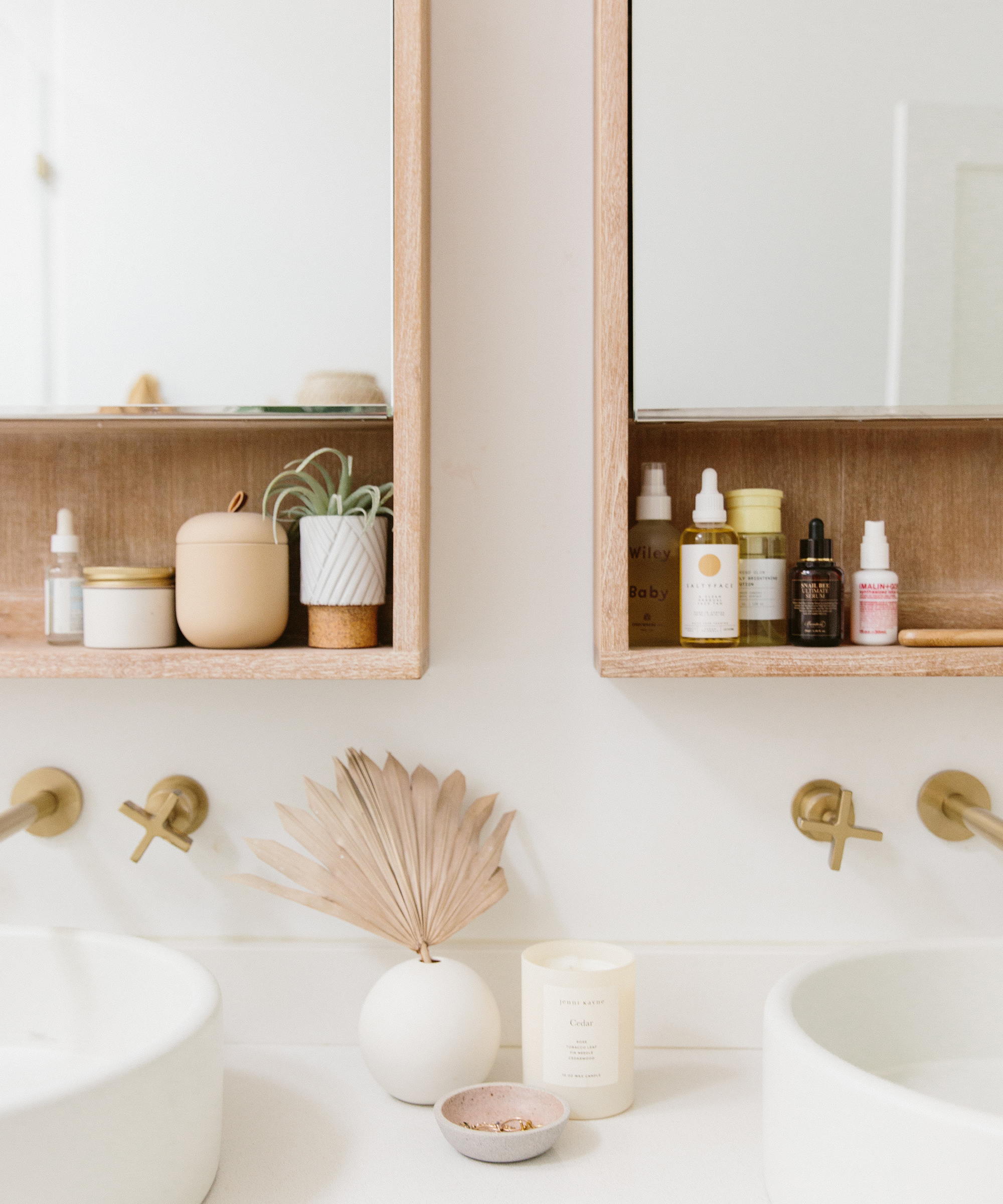 Molly Madfis of Almost Makes Perfect's bathroom countertop with a jenni kayne cedar candle on top.
