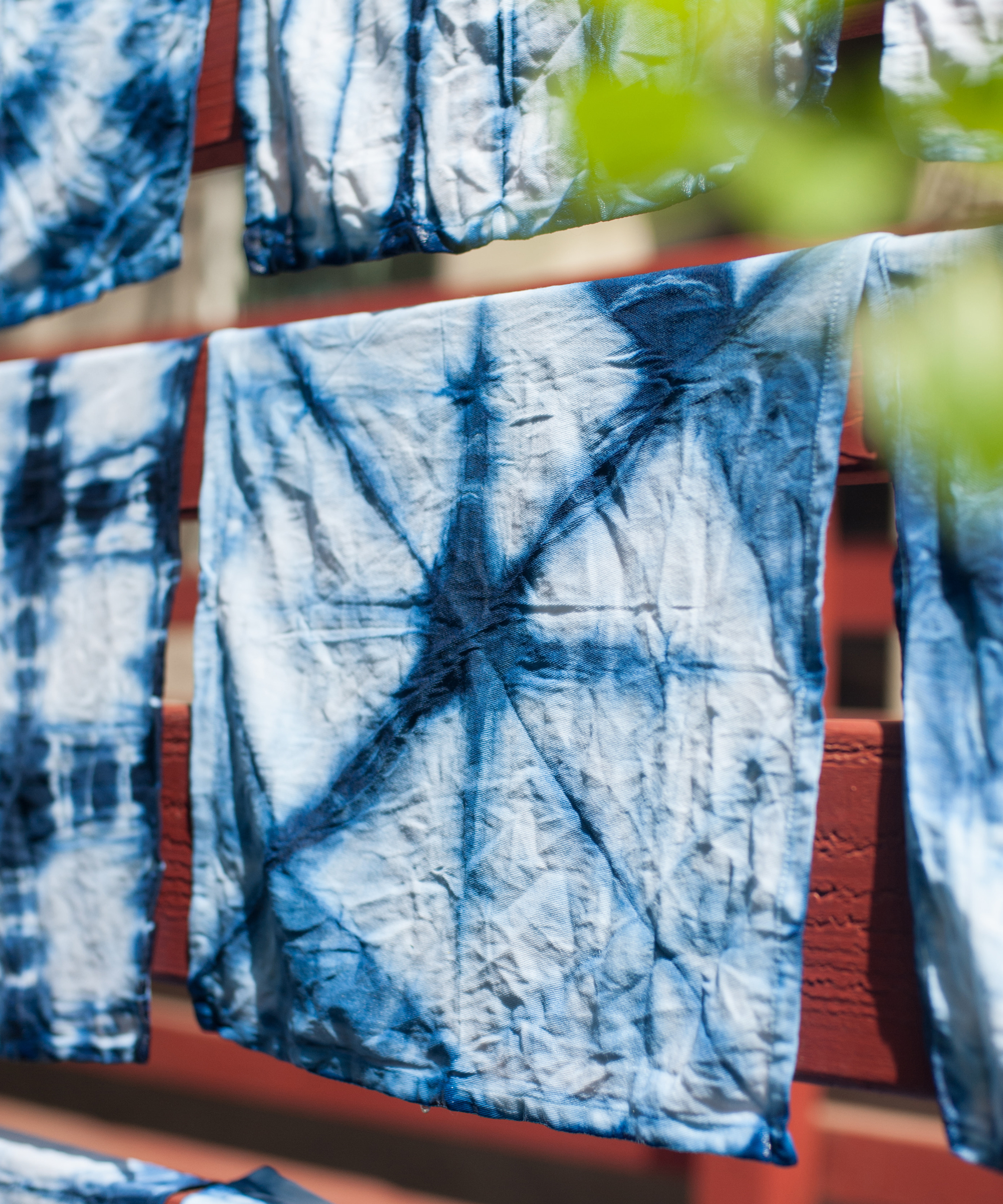 Tie-dyed linen napkins hanging on outside drying in the sun.