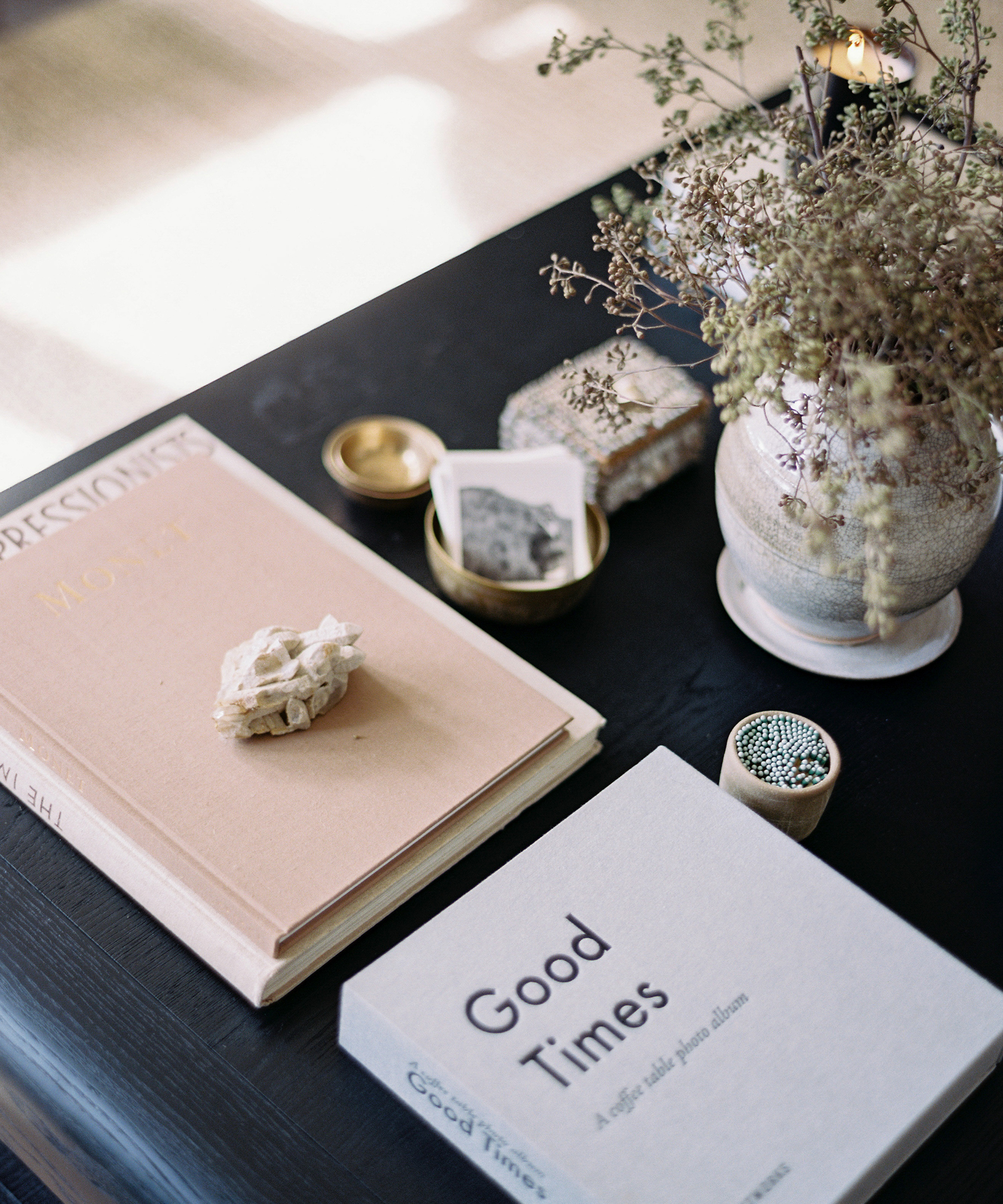 Kennesha Poe-Buycks of Restoration House's coffee table with books and a vase with flowers on top.
