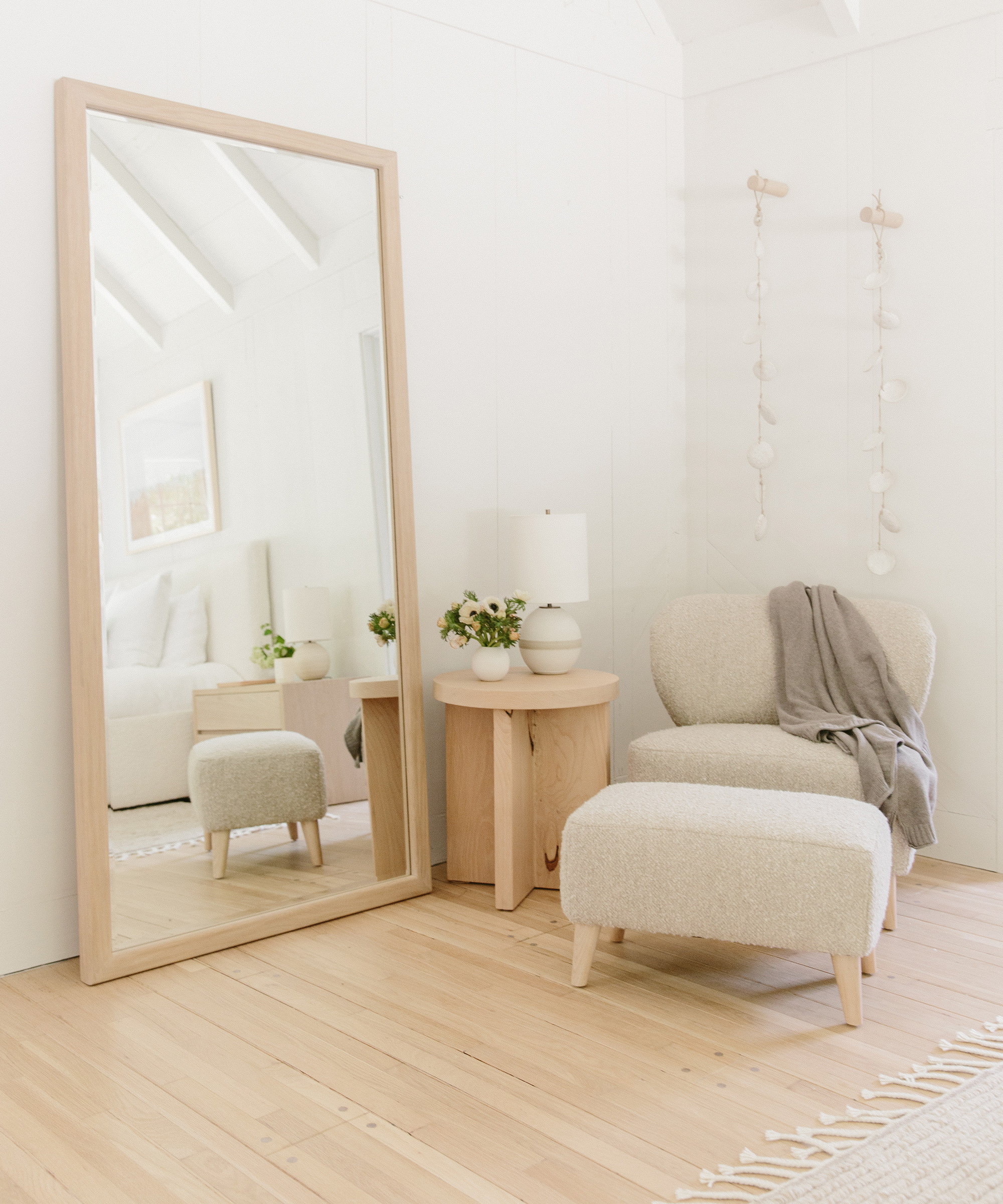 Julia Hunter's Mandeville Canyon bedroom with oak mirror, brentwood boucle chair and ottoman, and marin side table.
