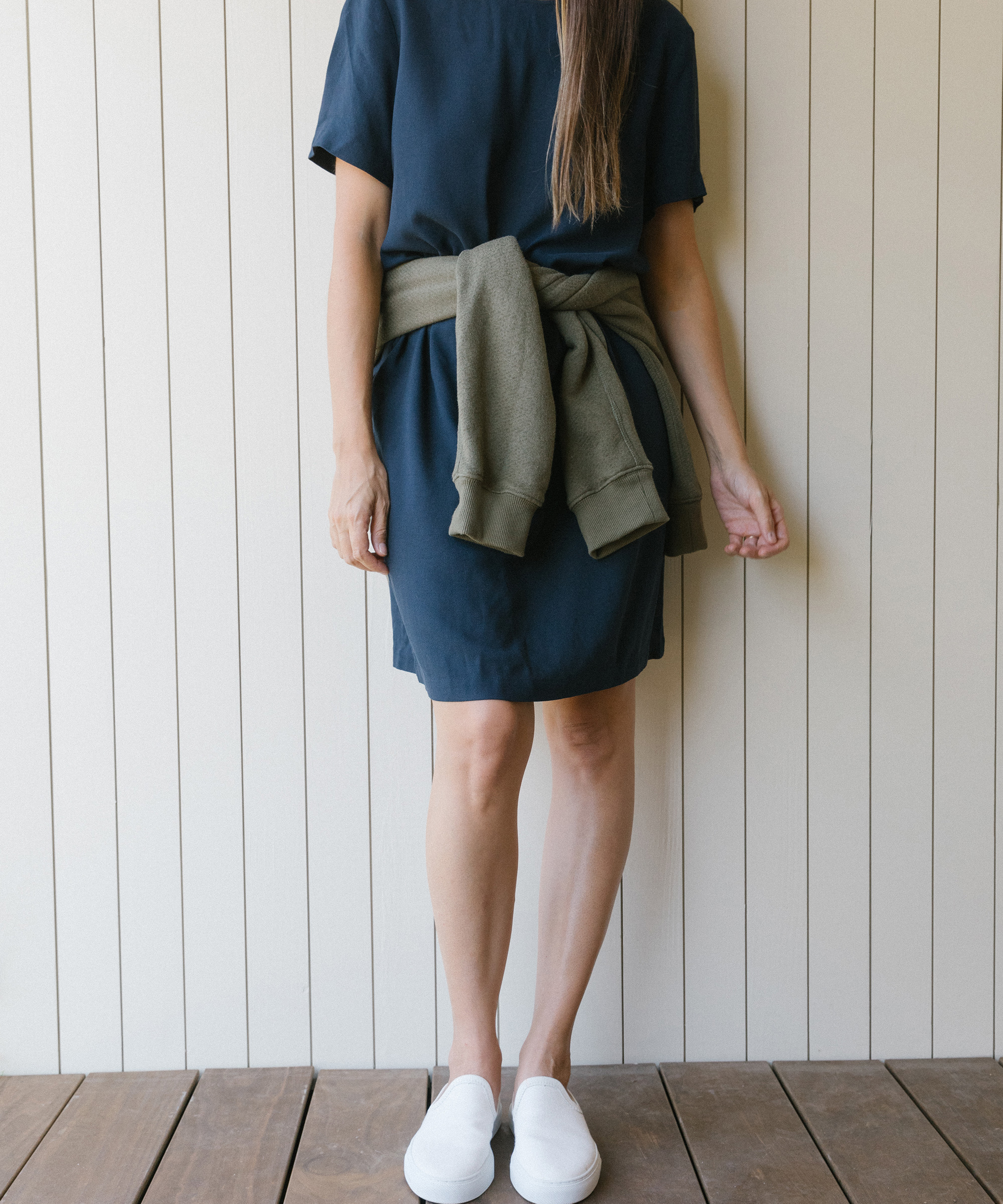 Kate Brien standing against a white wall wearing