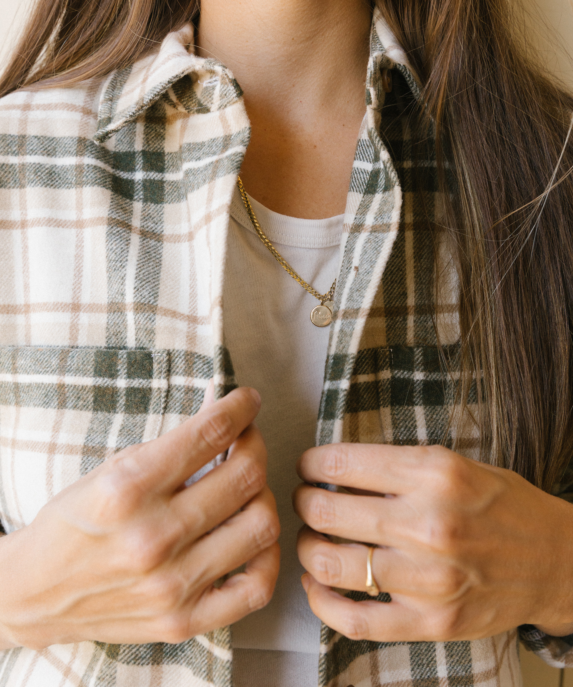 model wearing plaid overshirt with white jeans and white tee.