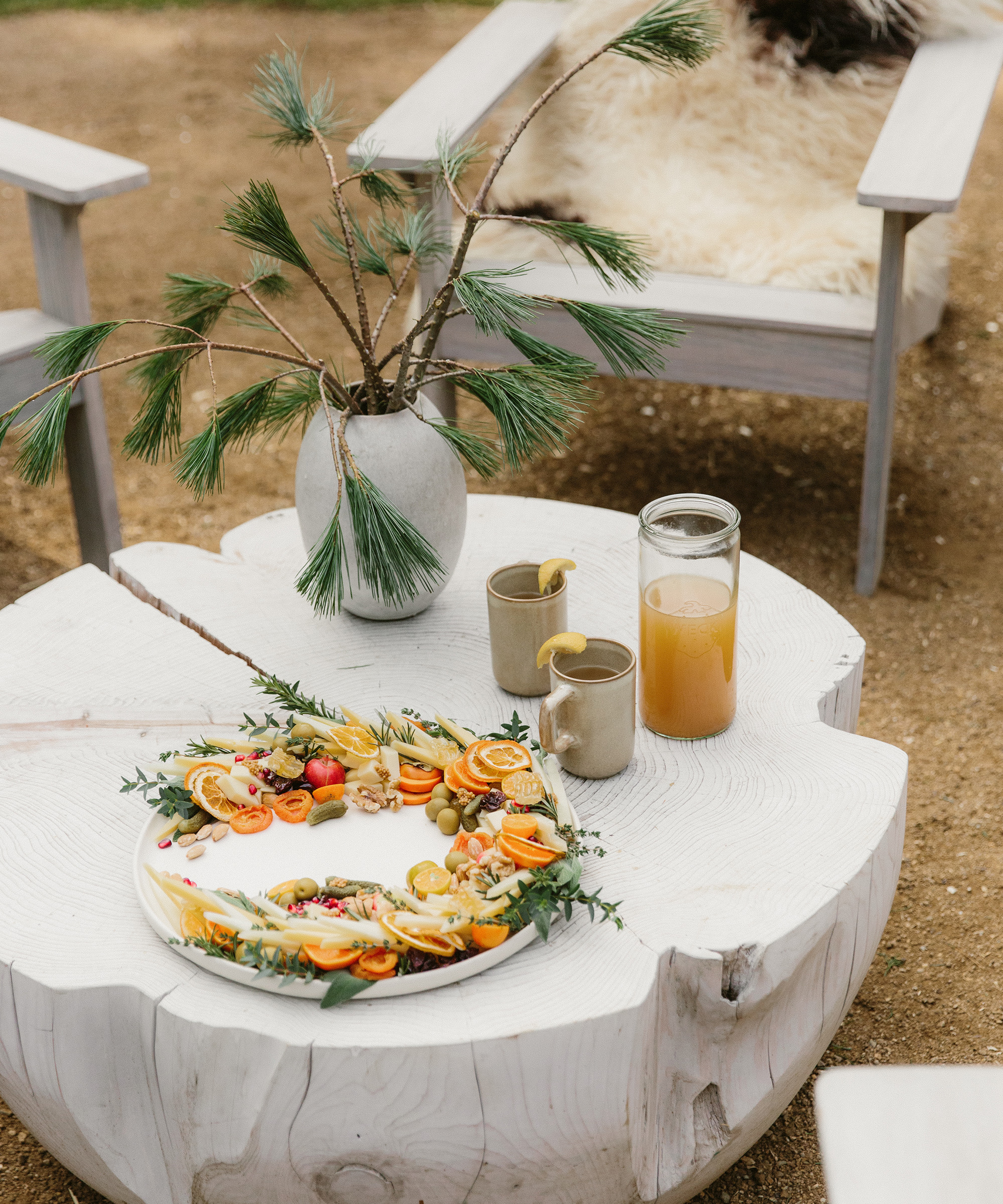 cheese wreath from lady & larder sitting on a table with jenni kayne dinnerware