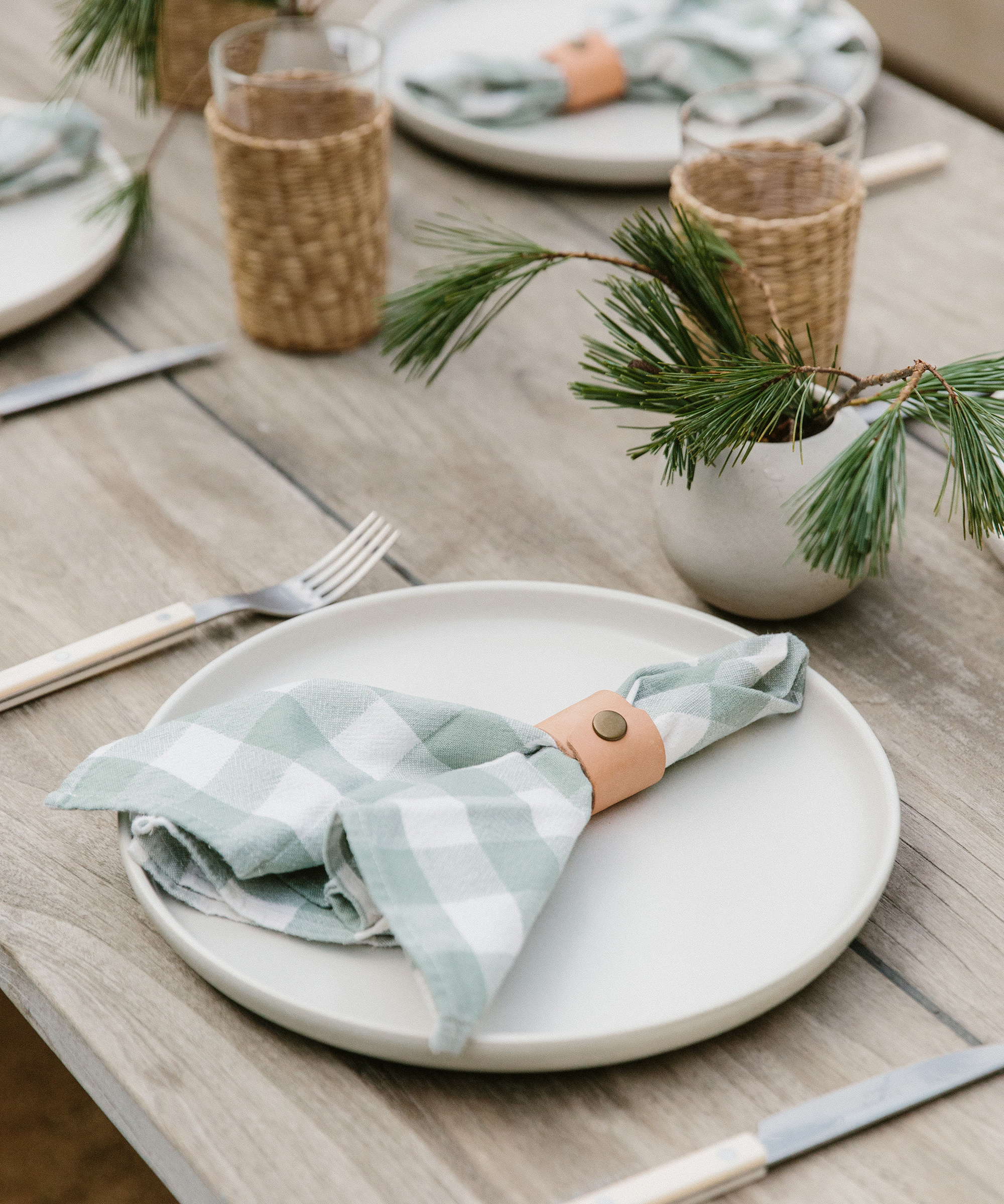 tabletop with plaid napkins and jenni kayne pacific dinner plate in ivory