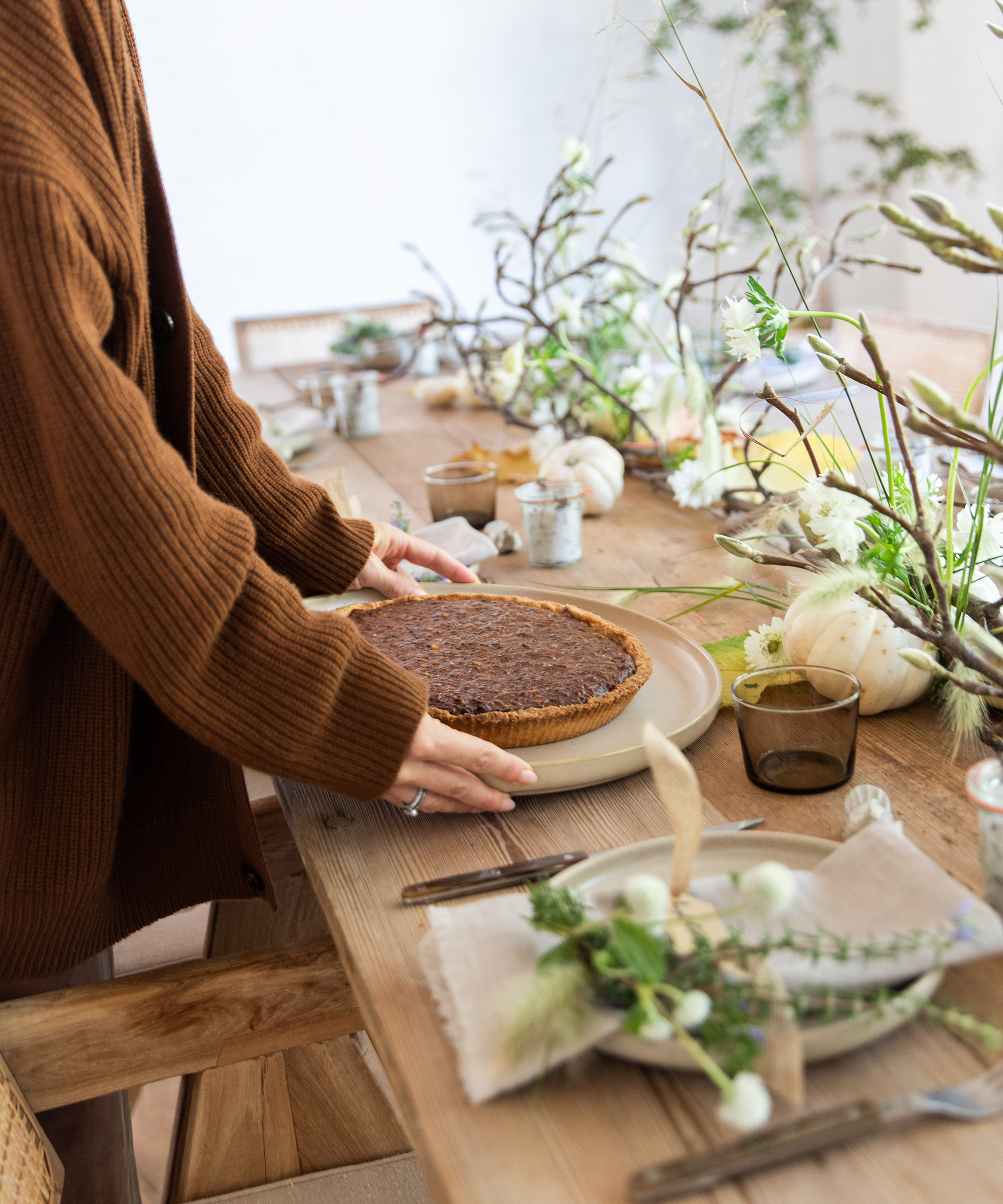 jenni placing pecan pie on the thanksgiving table