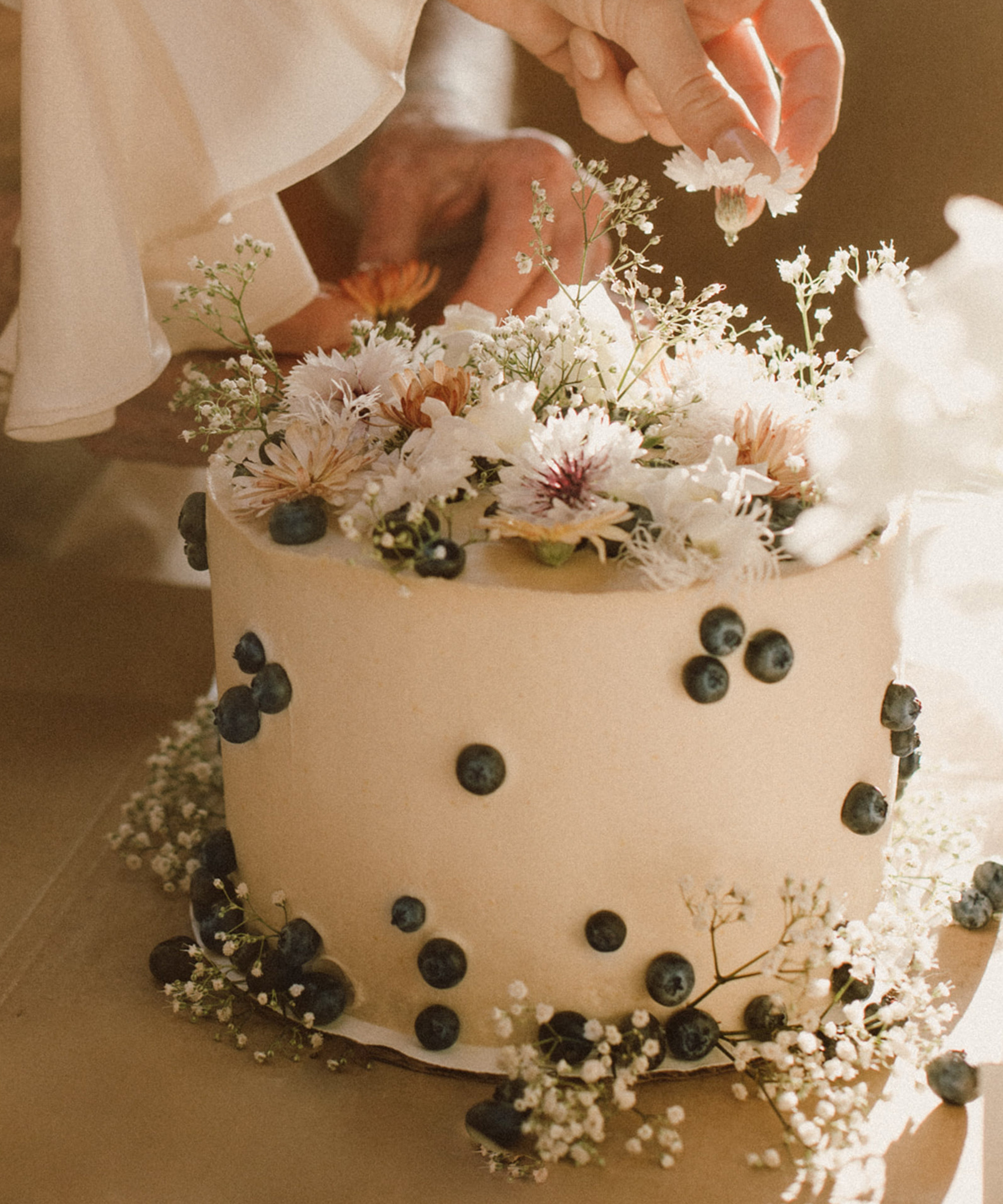 image of a wedding cake with florals on top