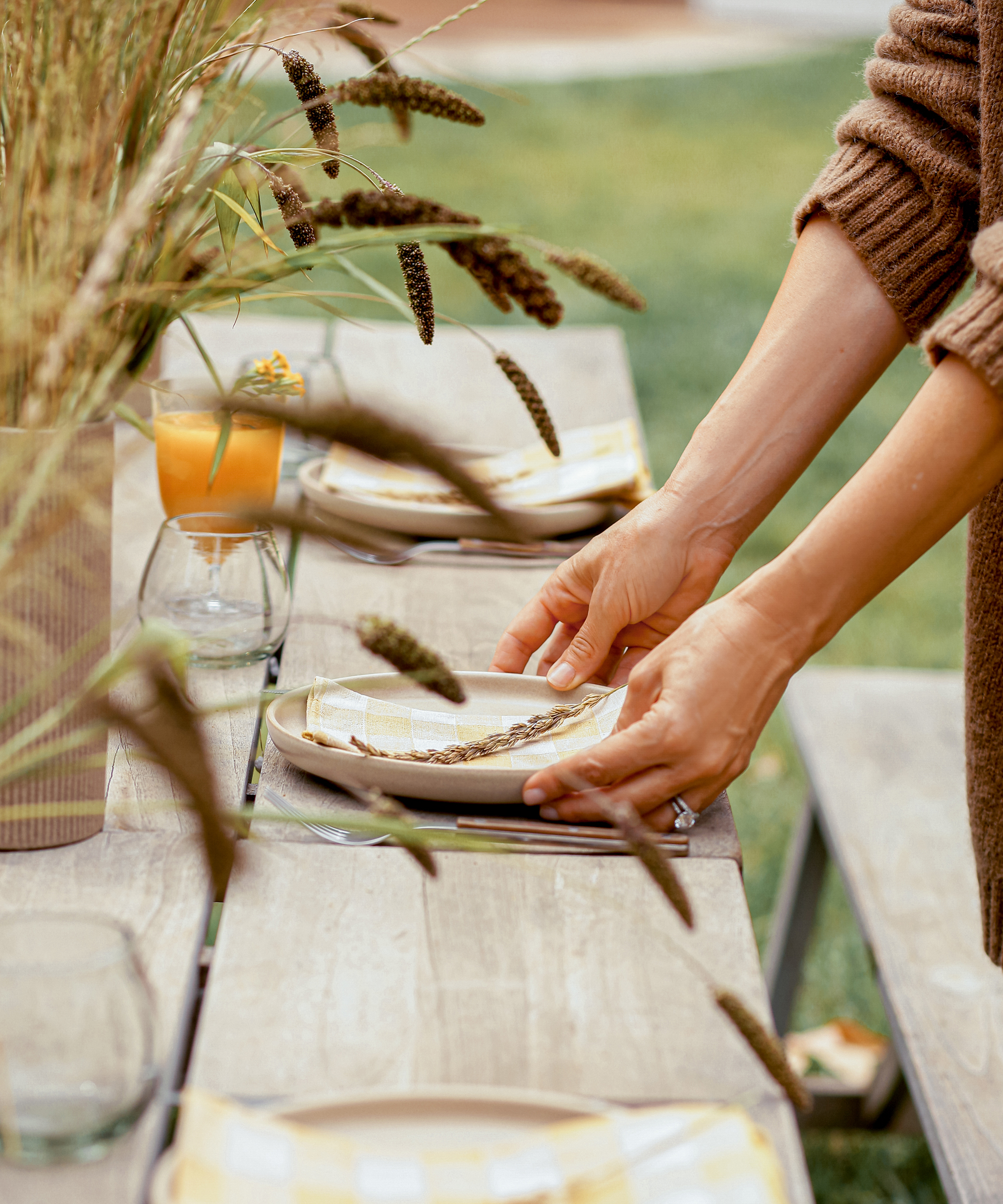 image of jenni kayne placing a plate down on her fall tabletop