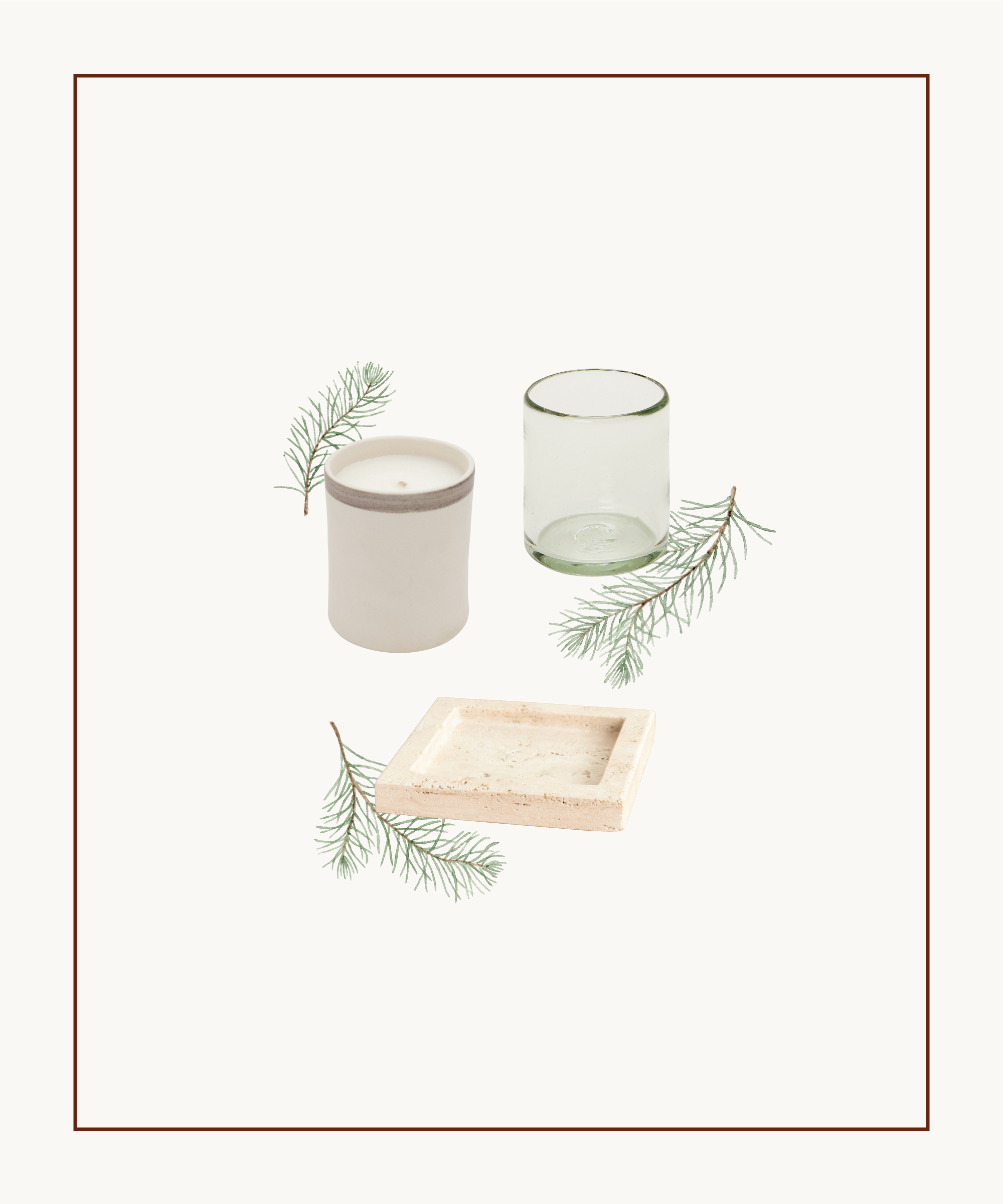 A white candle in a ceramic holder, a clear glass, and a square wooden tray are arranged on a white background with green pine sprigs—styling inspired by Colin King.