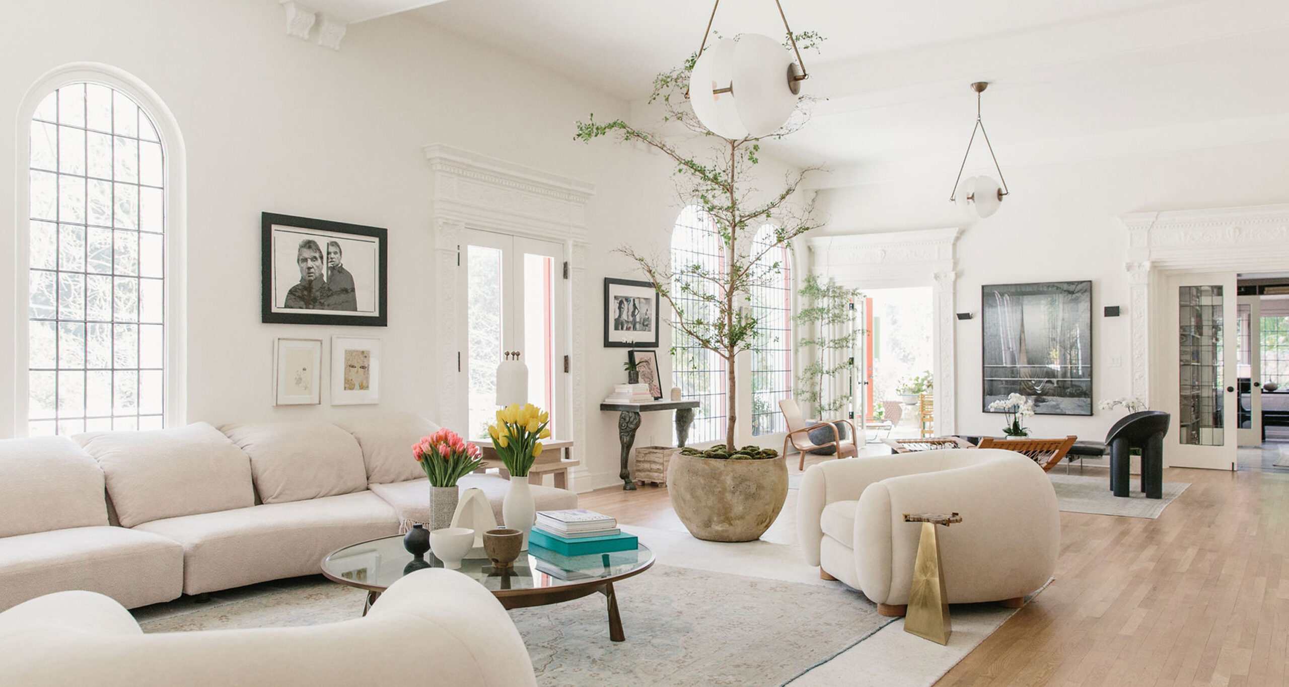 white living room with large accent chair and sectional couch