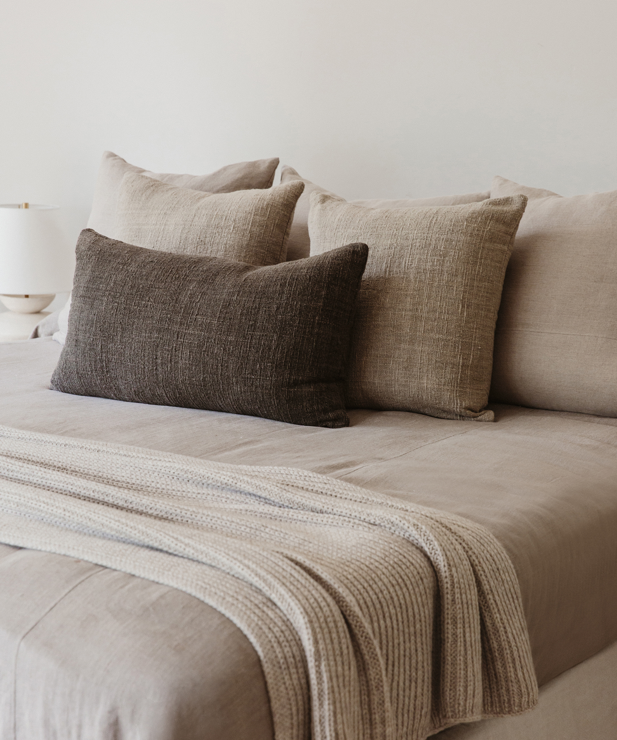 light grey bedding with charcoal lumbar pillow