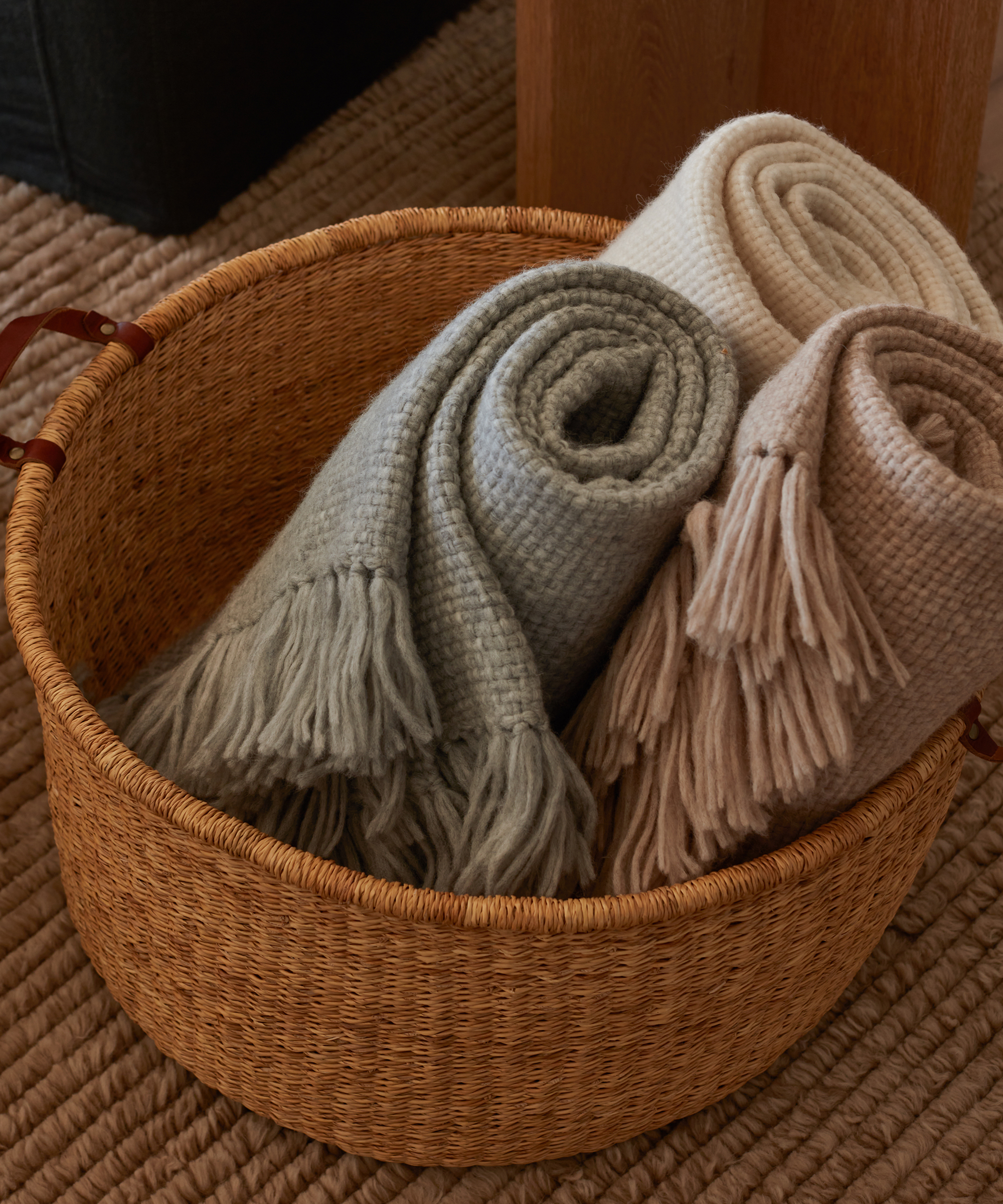 woven nesting basket with three alpaca basketweave throws