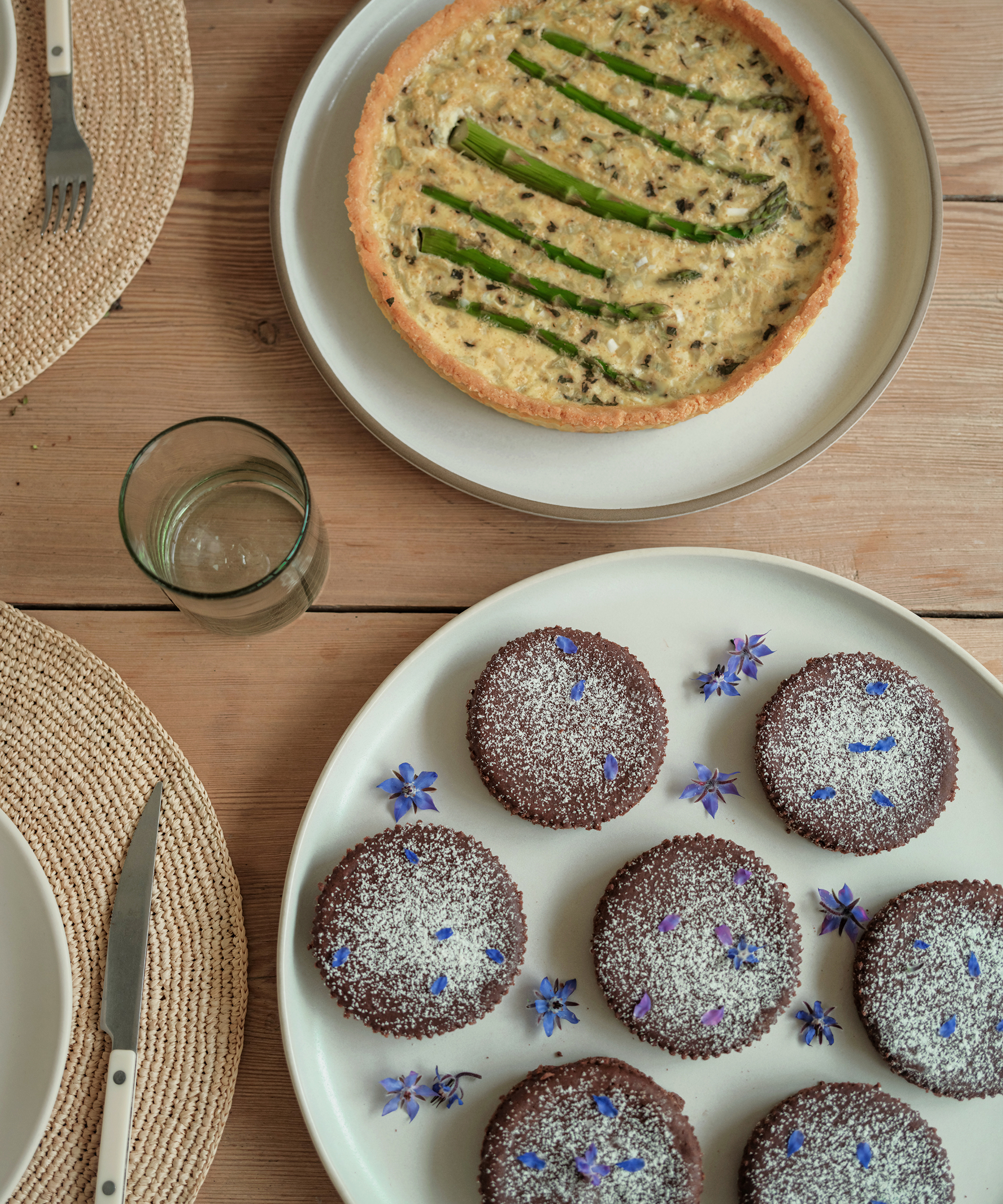 gluten free asparagus quiche on a jenni kayne platter and mini flourless chocolate cakes with powdered sugar and purple flowers on a jenni kayne platter