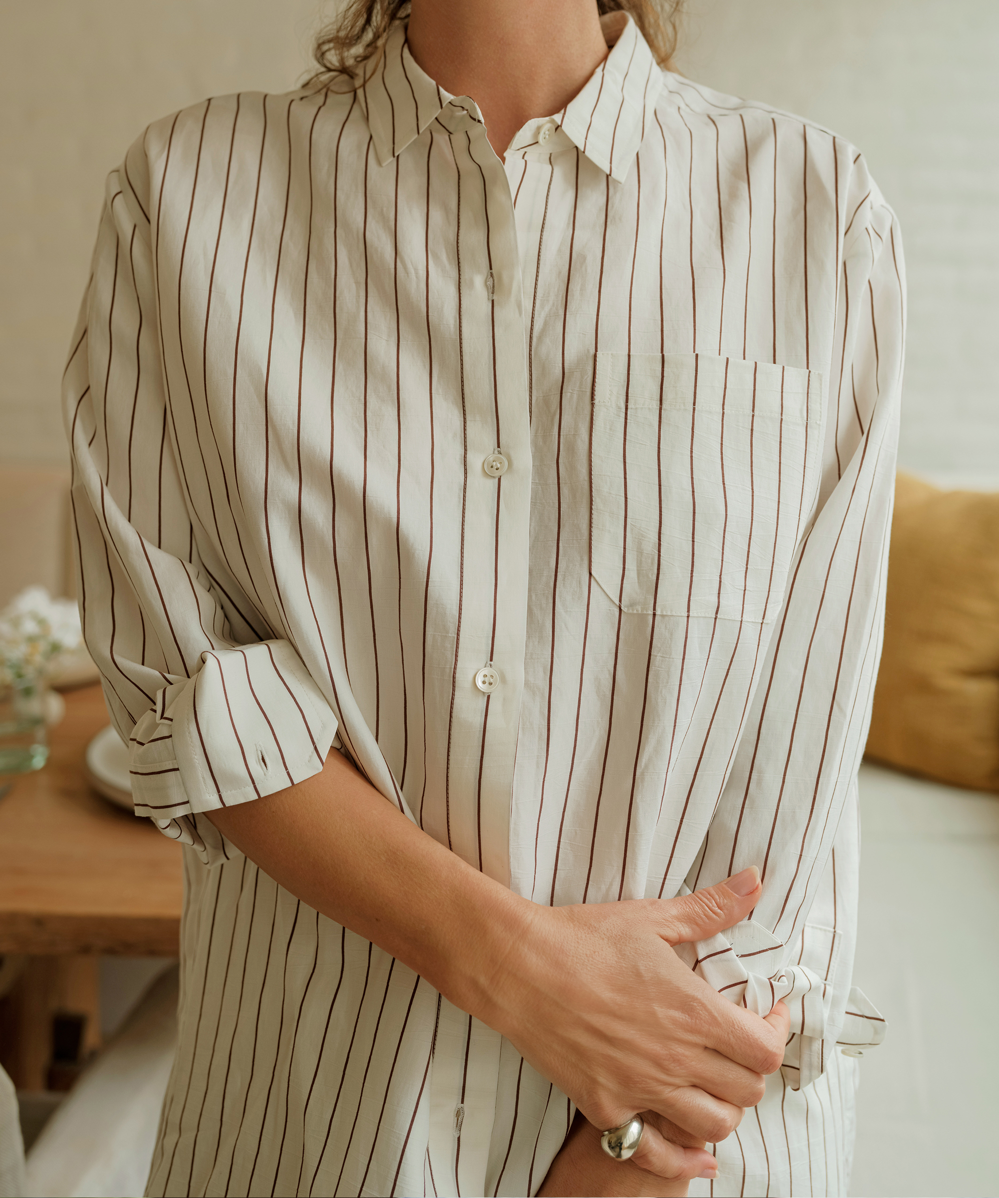 jenni kayne arms crossed in striped boyfriend shirt with a silver ring