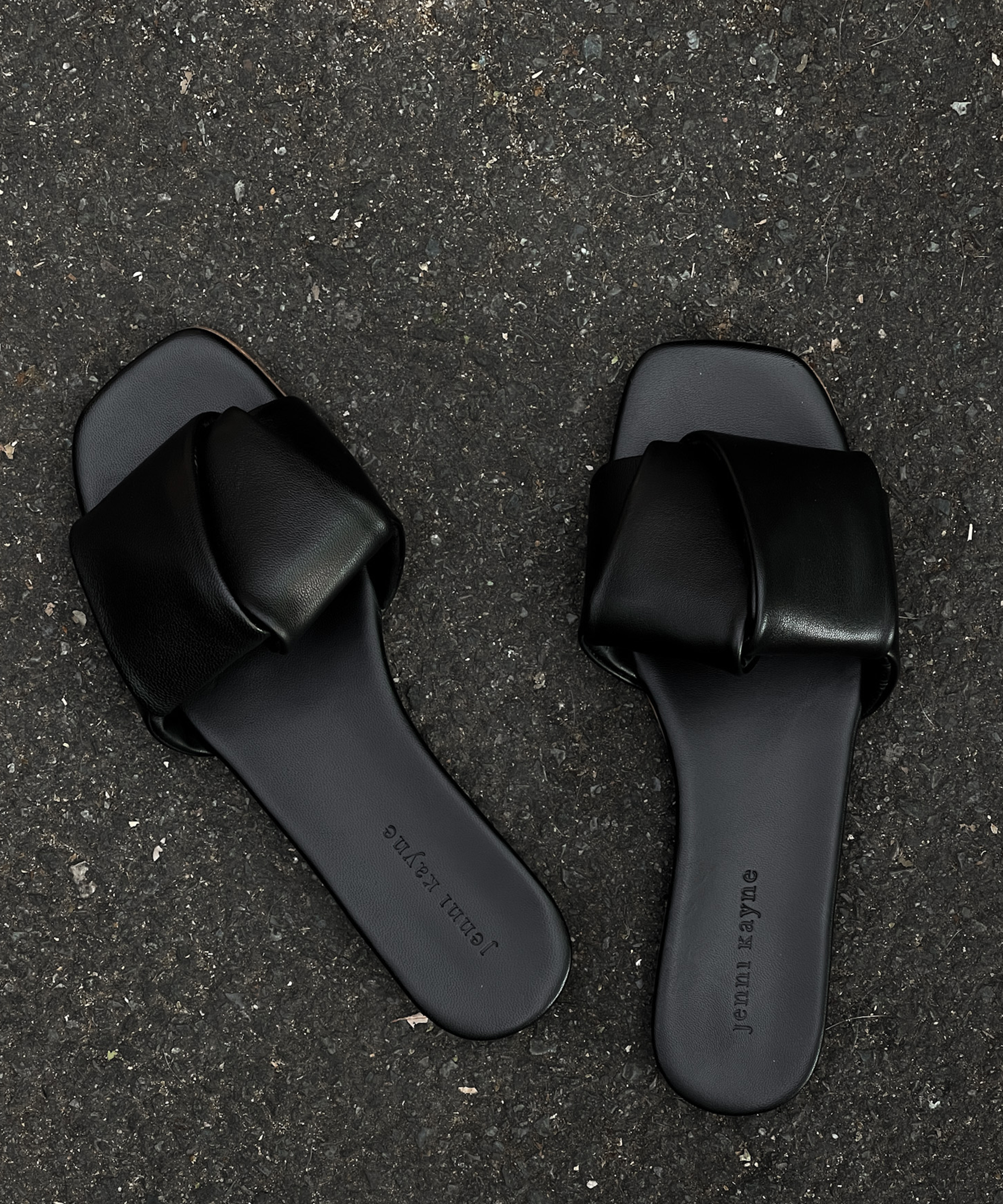 black dani slides on black pavement