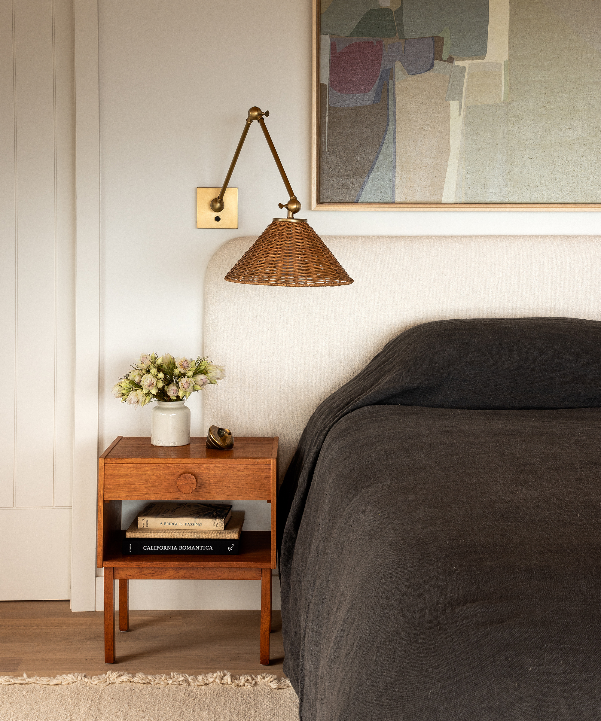 anne-mcdonald-home-tour-ivory-bed-rattan-sconce-wood-side-table