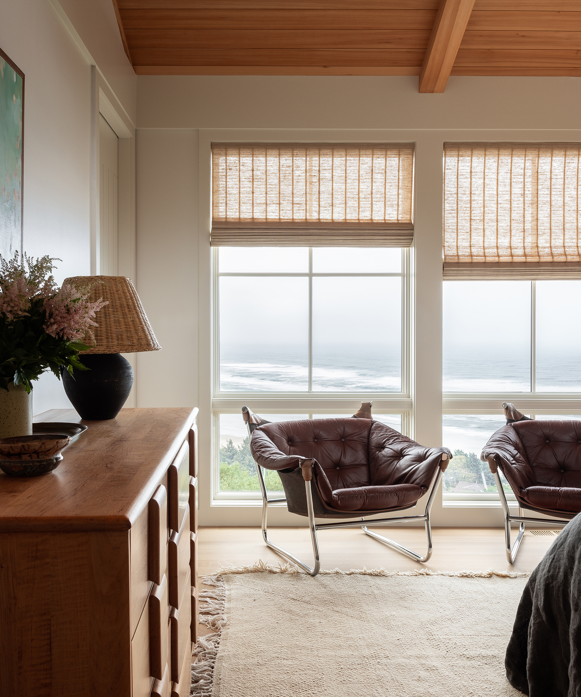 anne-mcdonald-home-tour-two-leather-accent-chairs-ocean-view-bedroom