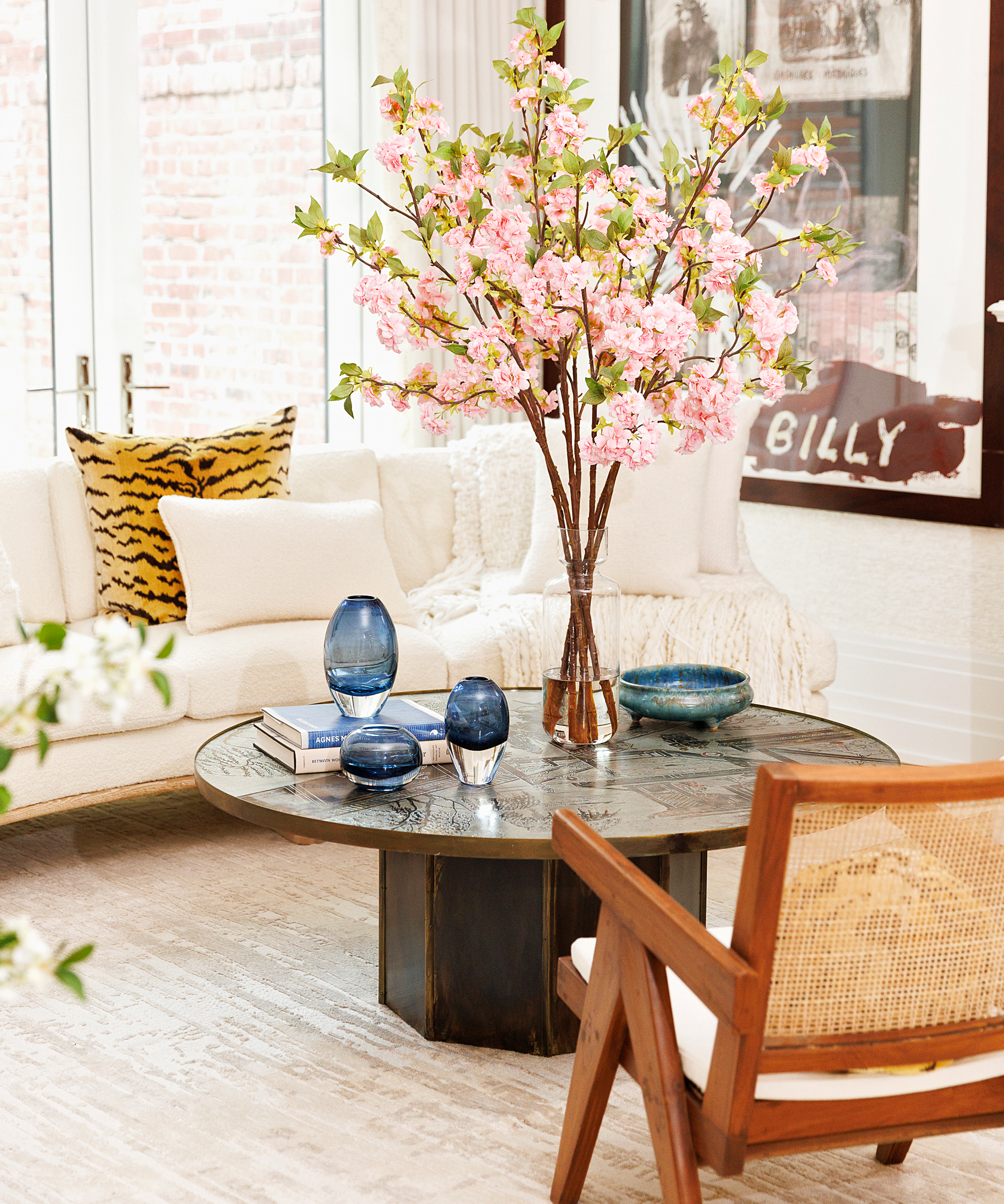 ashley-stark-home-tour-curved-white-couch-pink-flowers-sitting-area