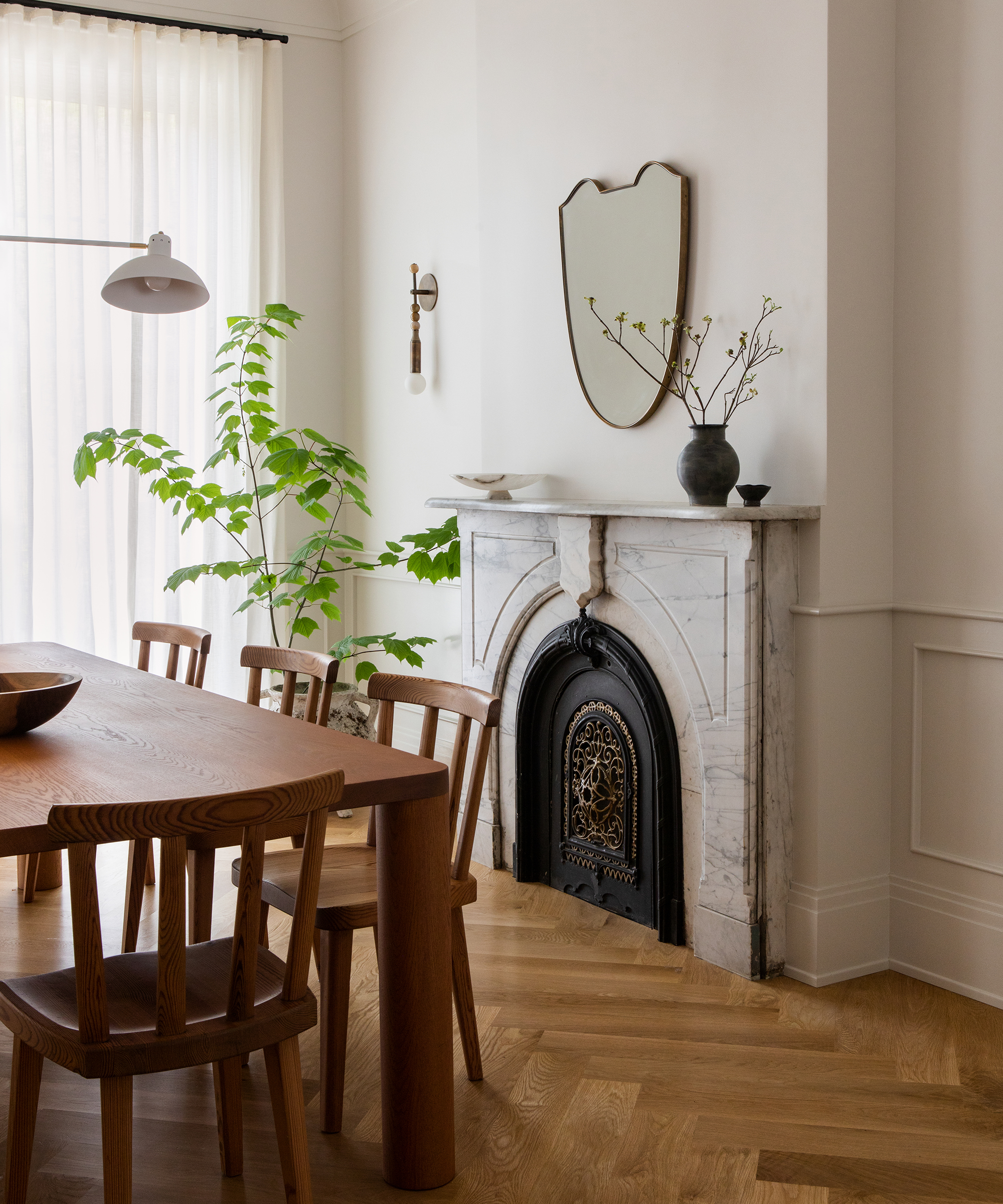 nune-home-tour-wood-dining-room-marble-fireplace