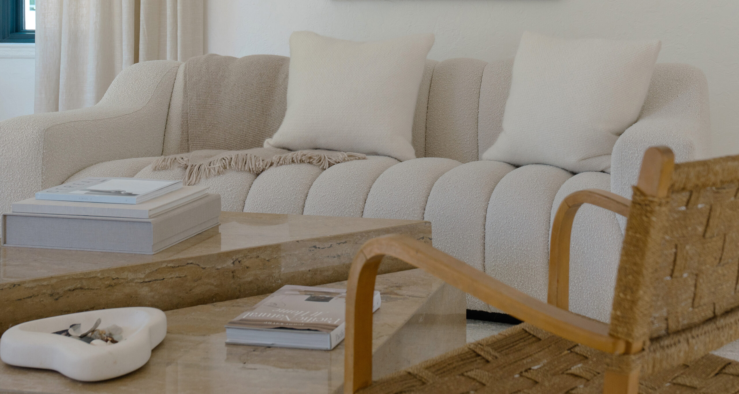 laura-murray-home-tour-curved-couch-travertine-table-alpaca-basketweave-pillows