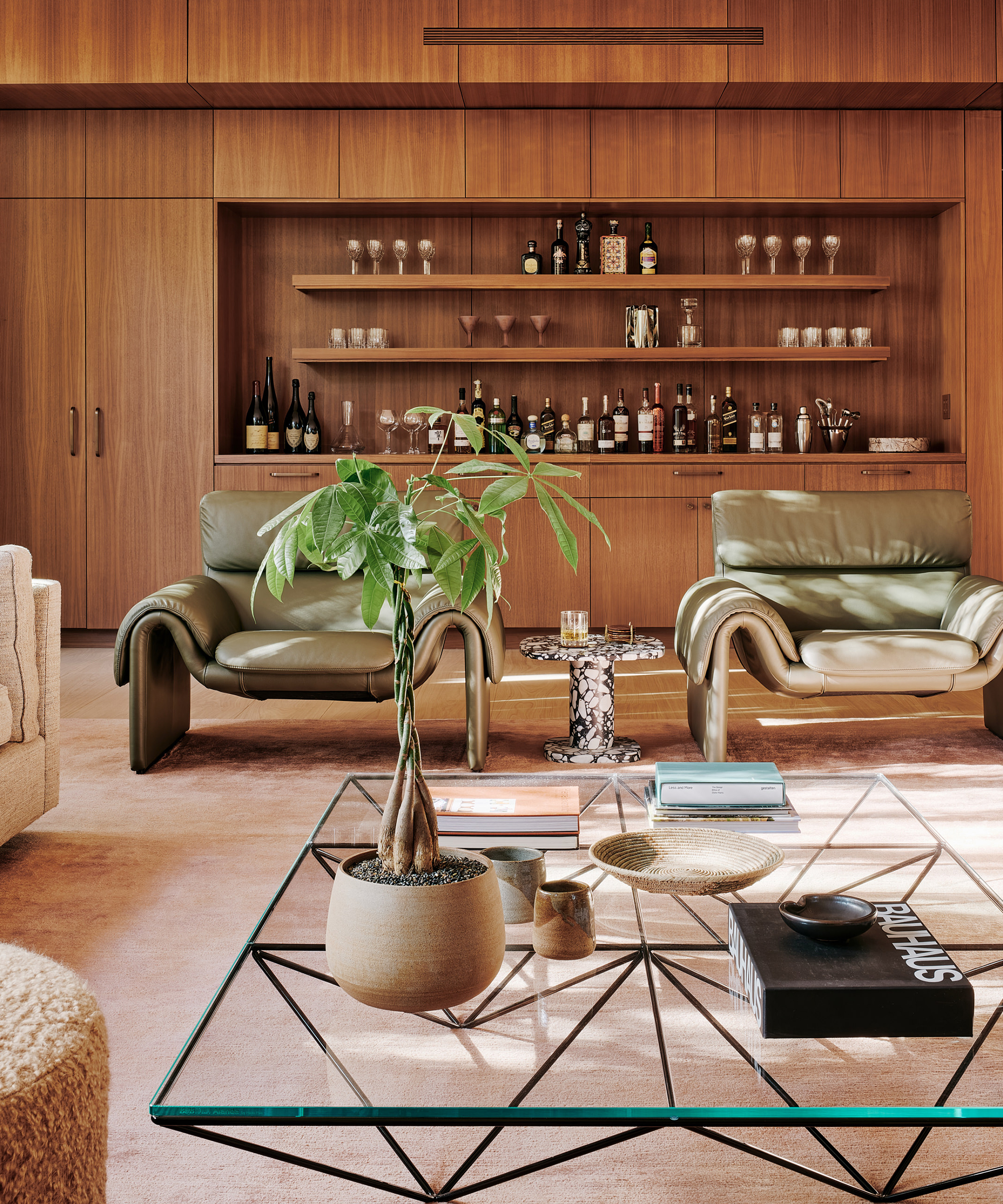 woods-danagarn-home-tour-green-leather-accent-chairs-brown-bar