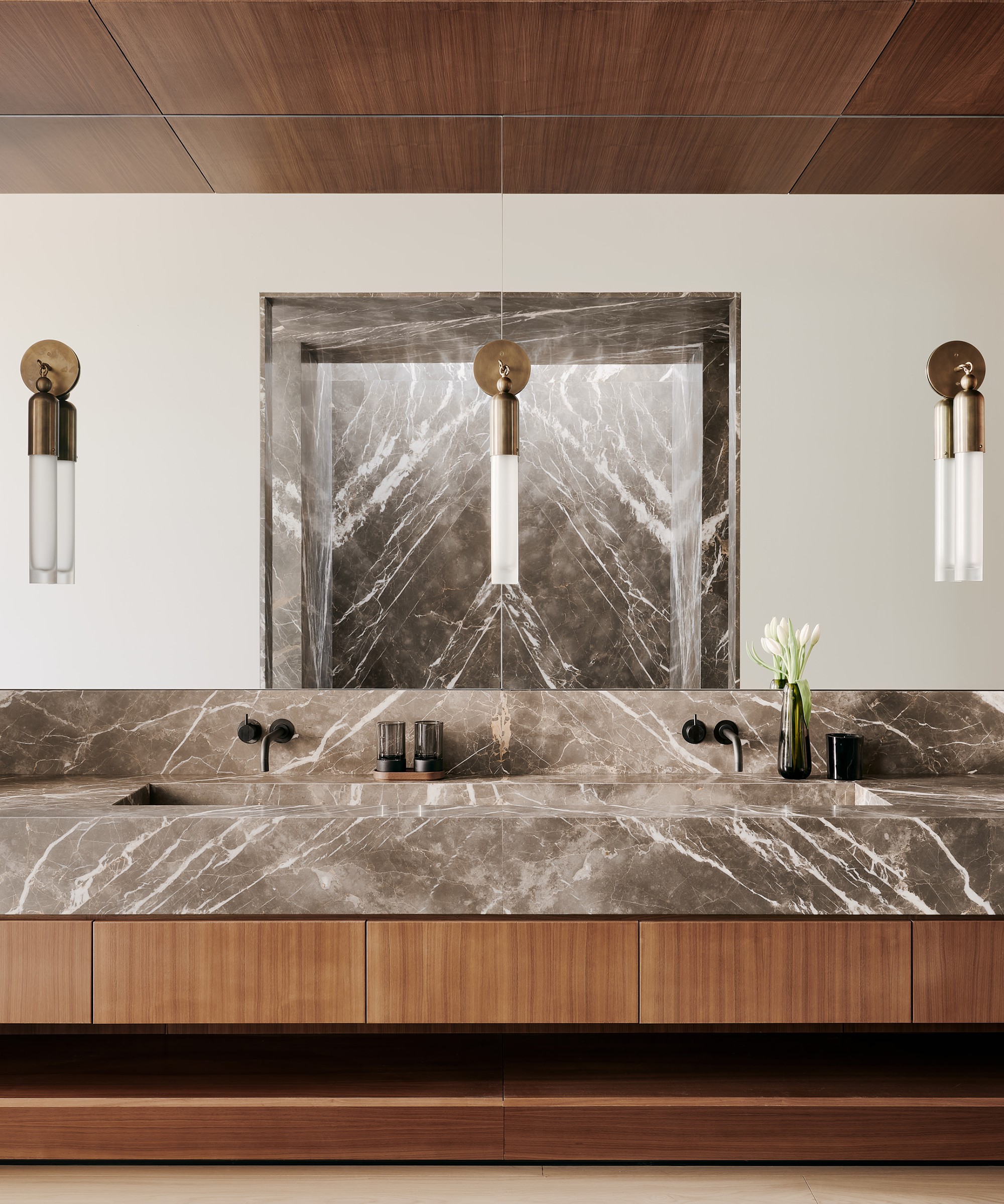 woods-dangaran-home-tour-grey-marble-primary-bathroom-brass-sconces