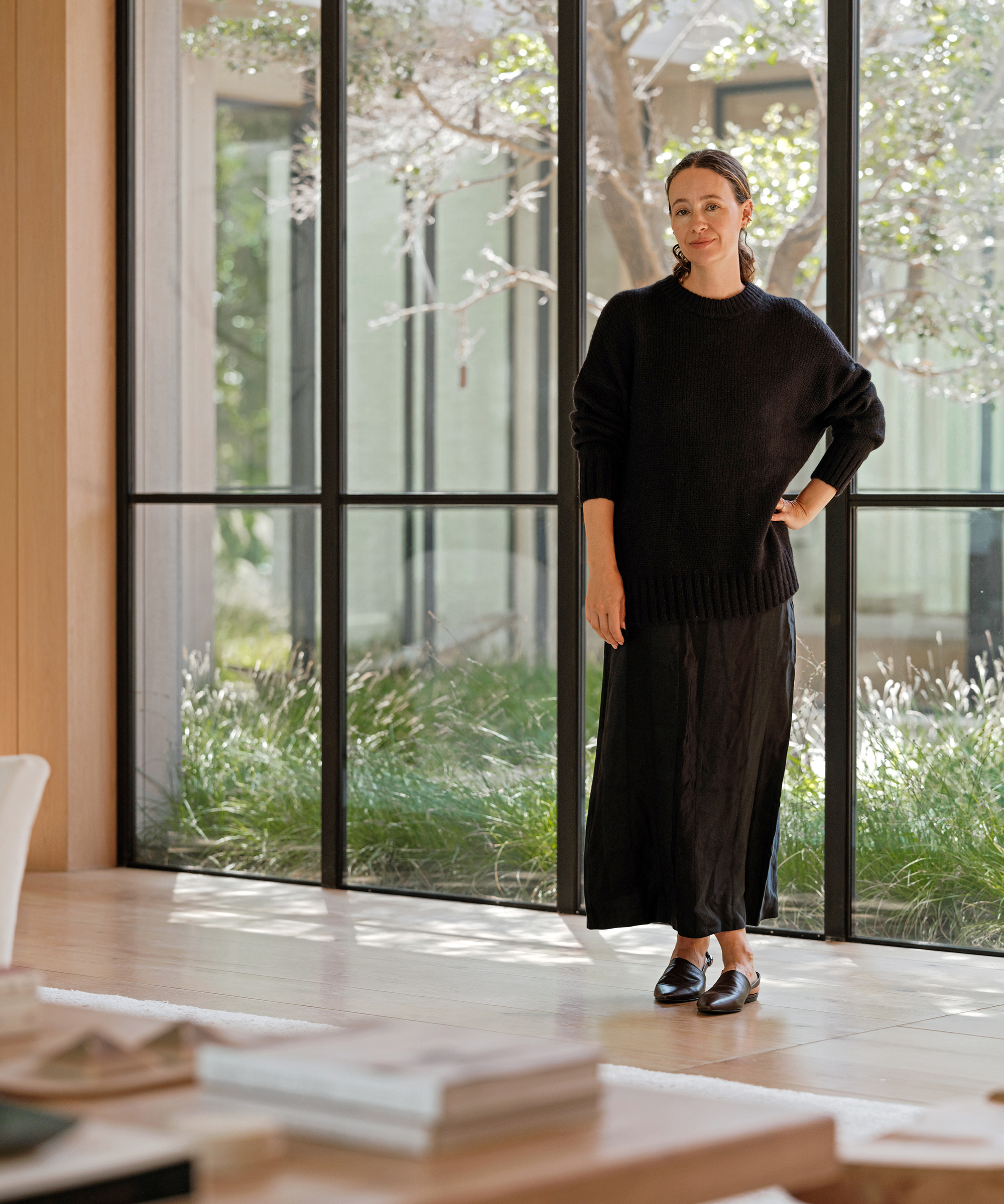 jenni kayne in a black pullover sweater over a black shift dress and chocolate slingback mules