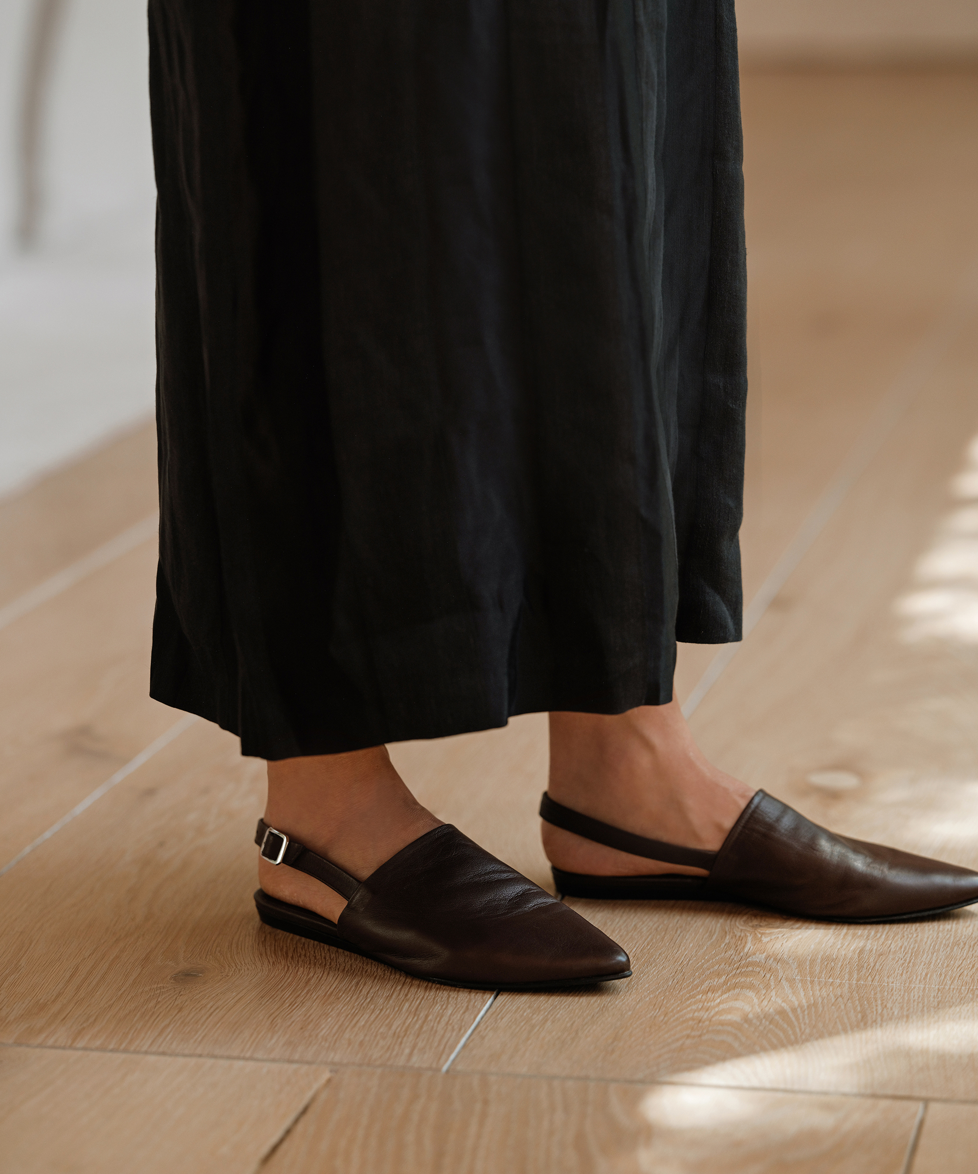 chocolate slingback mules styled with a black maxi dress
