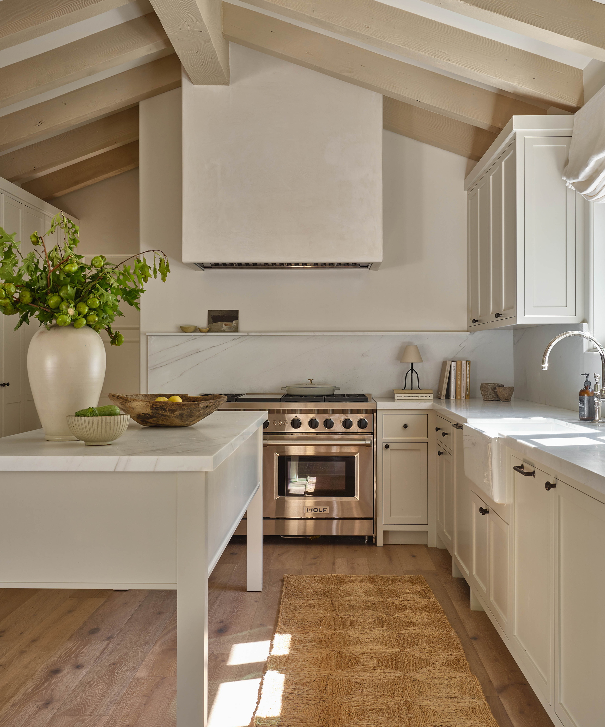 a creme kitchen with wood dining floors and a jute runner