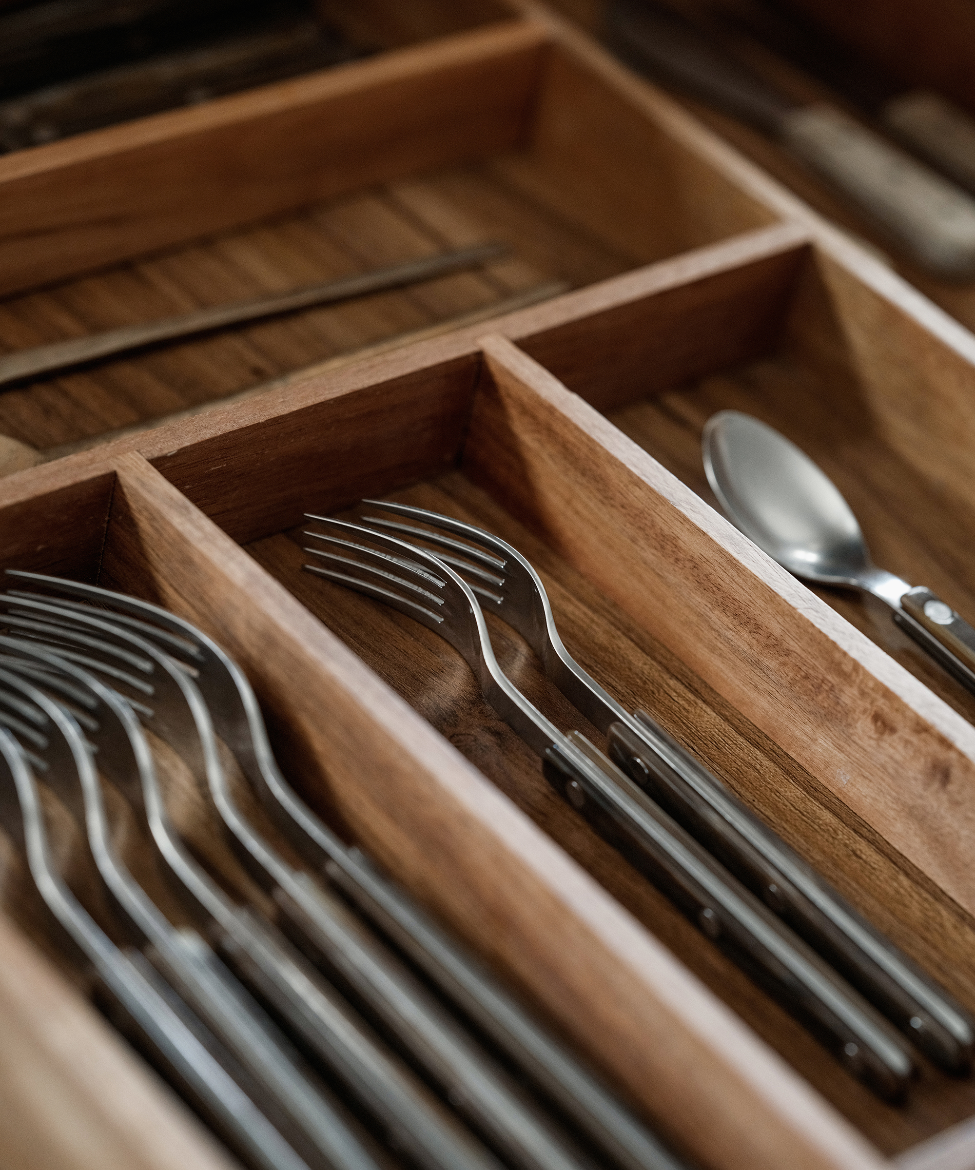 a drawer with dividers and cutlery spaced out in the dividers