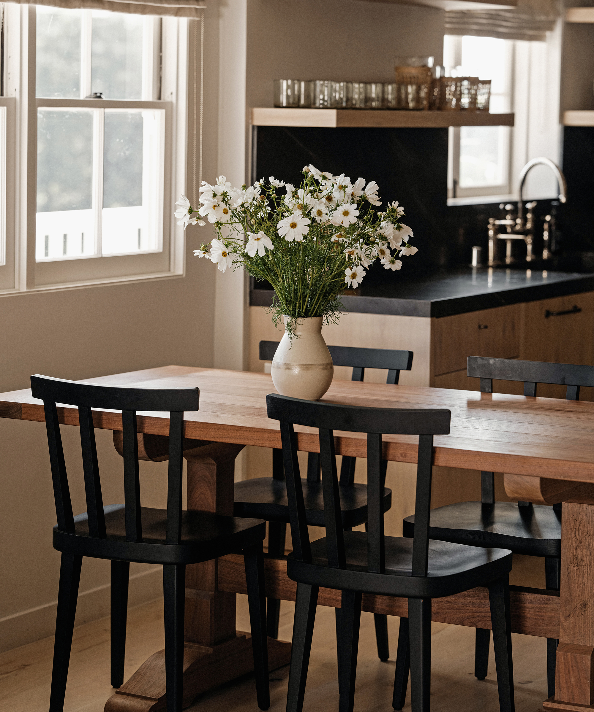 kitchen dining area with a wooden dining table and black wood dining chairs