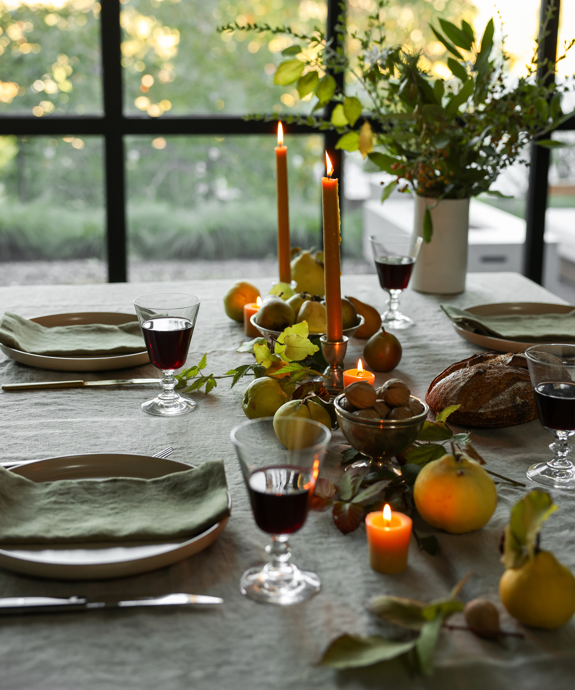 pacific dinner plate on a taupe linen tablecloth with an olive green napkin and a clear wine glass