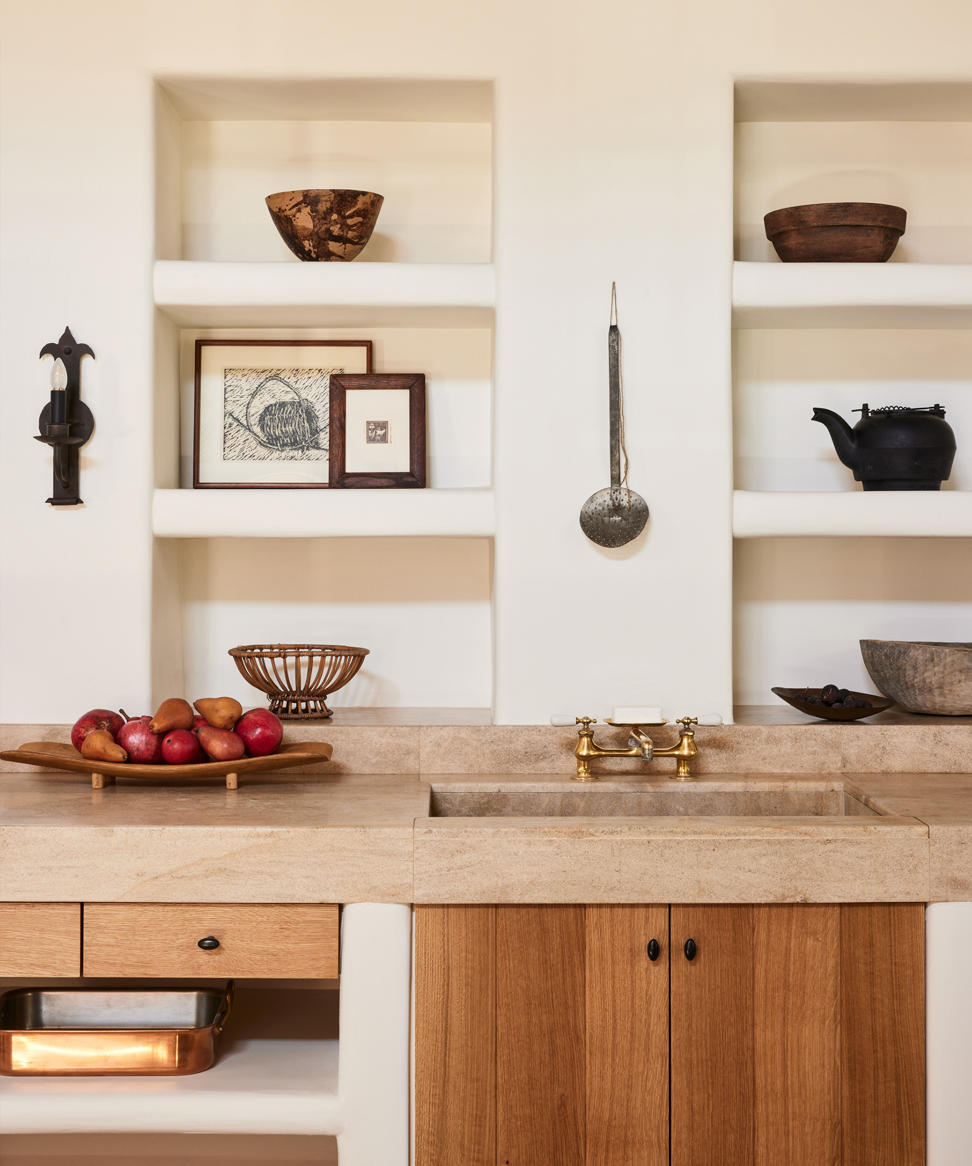 a kitchen with a wood cabinet doors and a stone counter with plaster open shelving