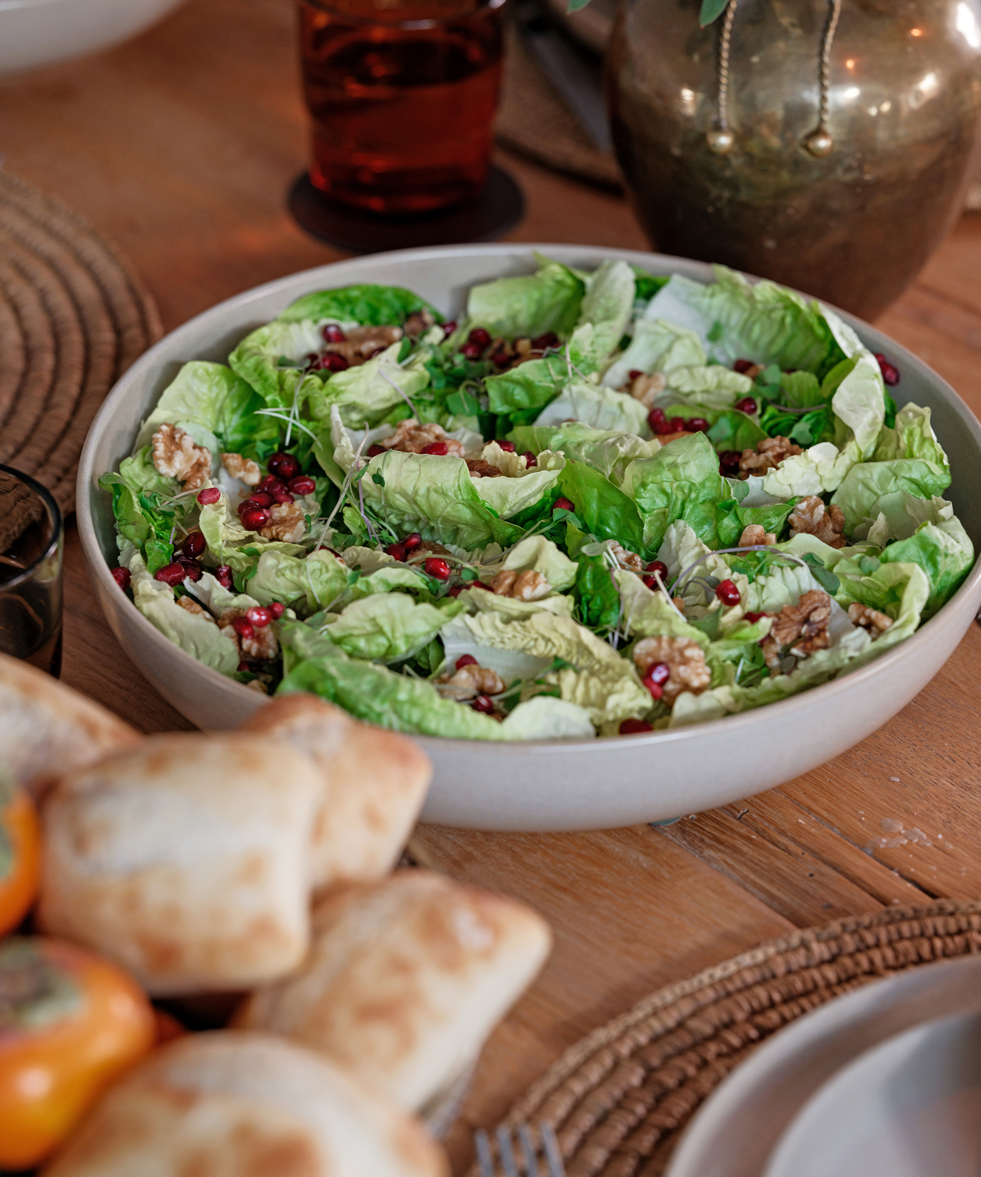 an ivory serving bowl with lettuce and pecans