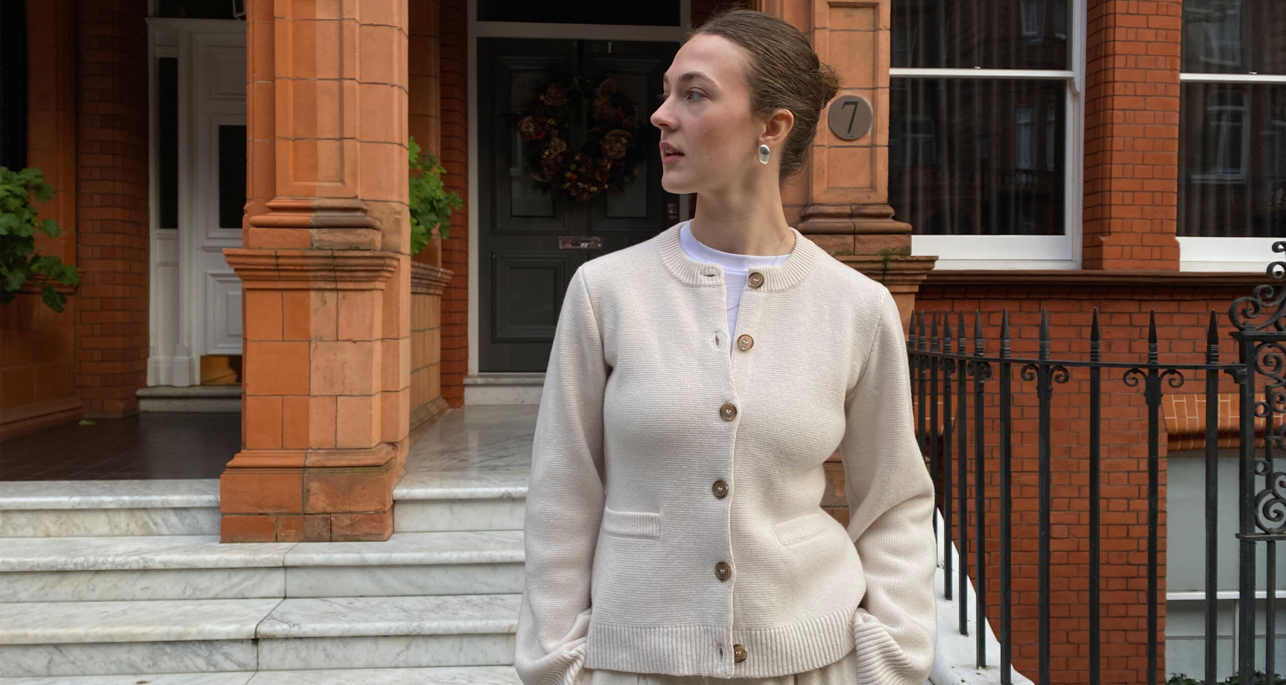 olivia-wayman-in-uniform-cooper-cardigan-brick-walls