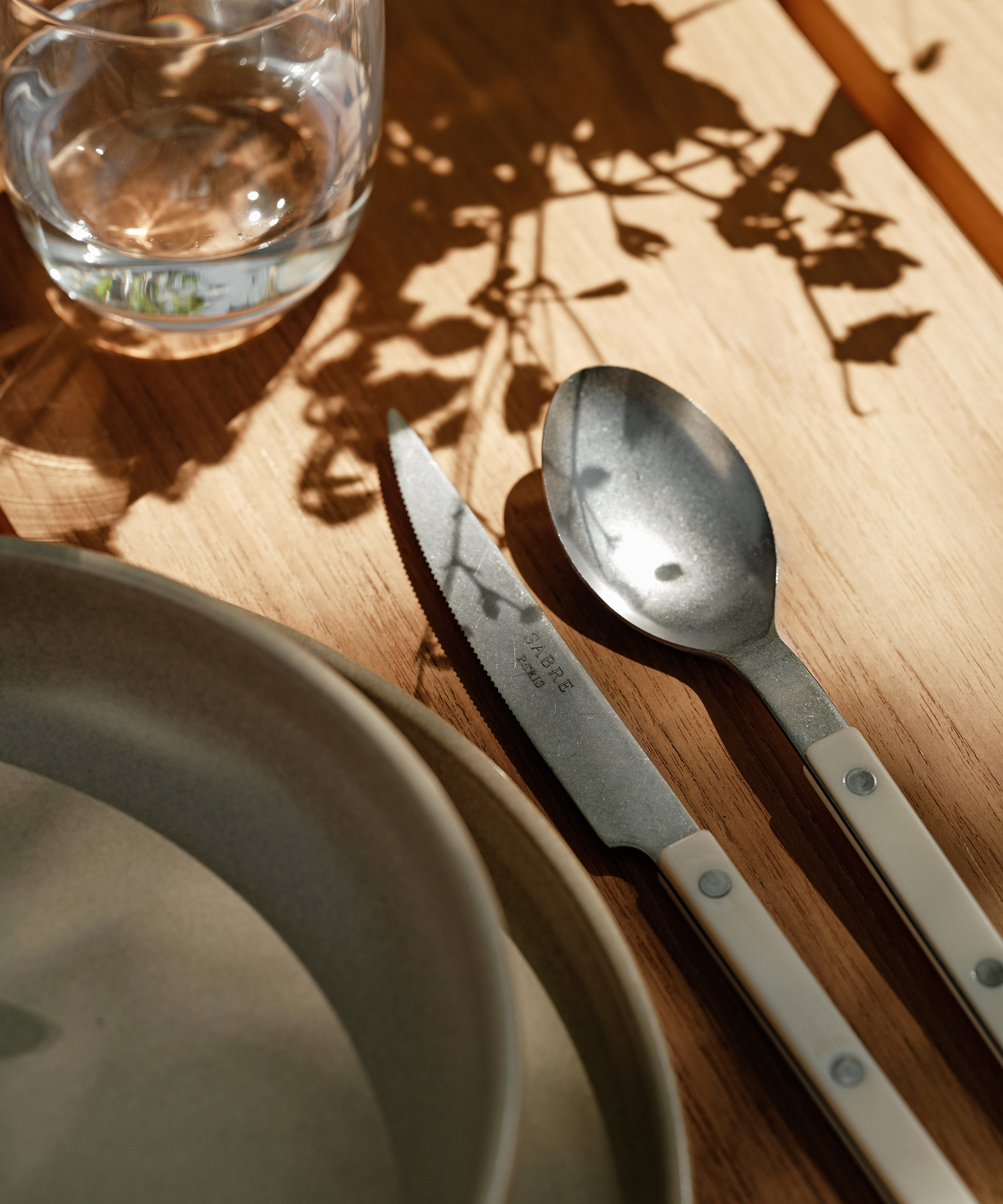 an outdoor dining table with ivory bistro vintage cutlery