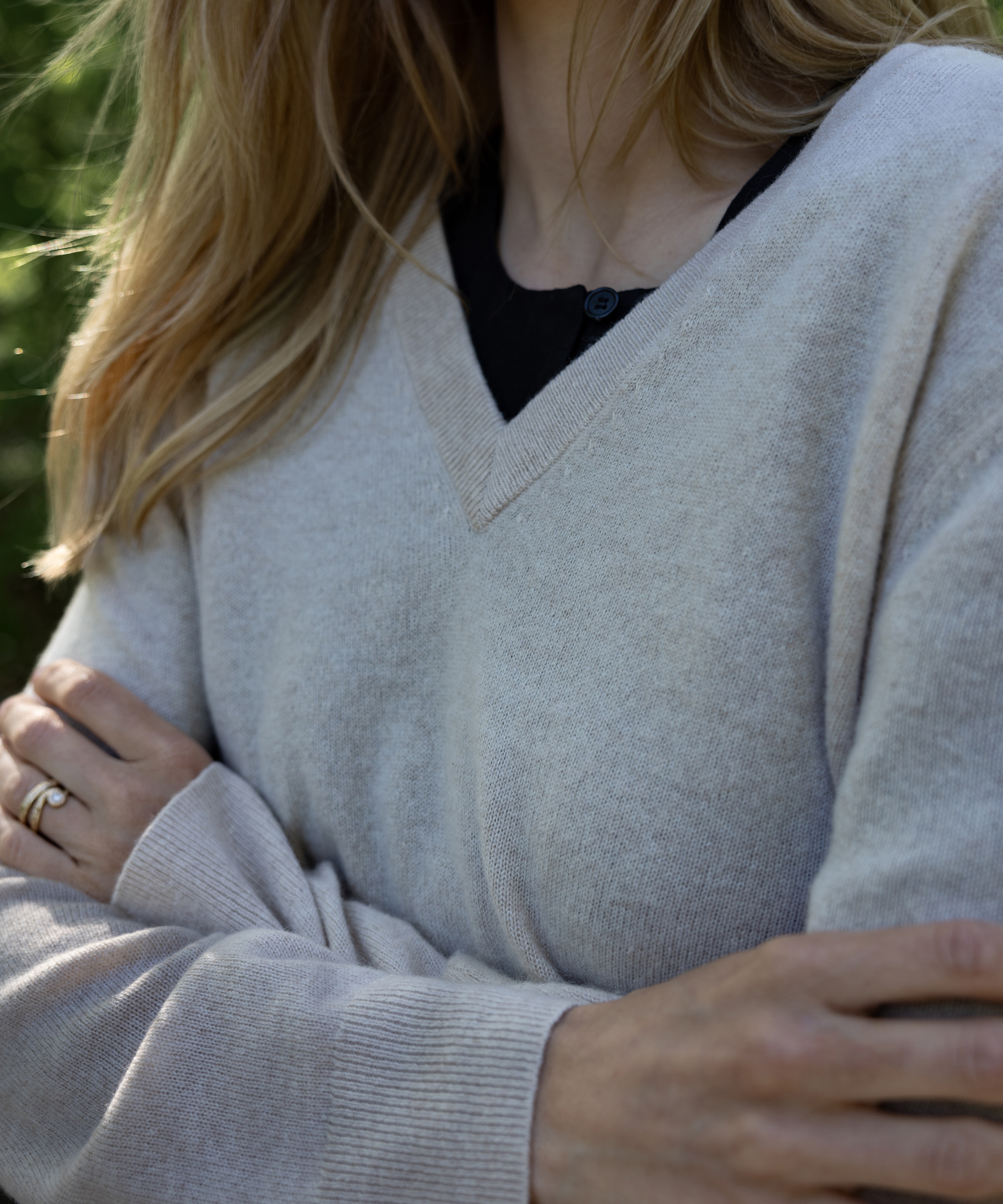 cecilie in an oatmeal flynn cashmere vneck with a black tee layered underneath