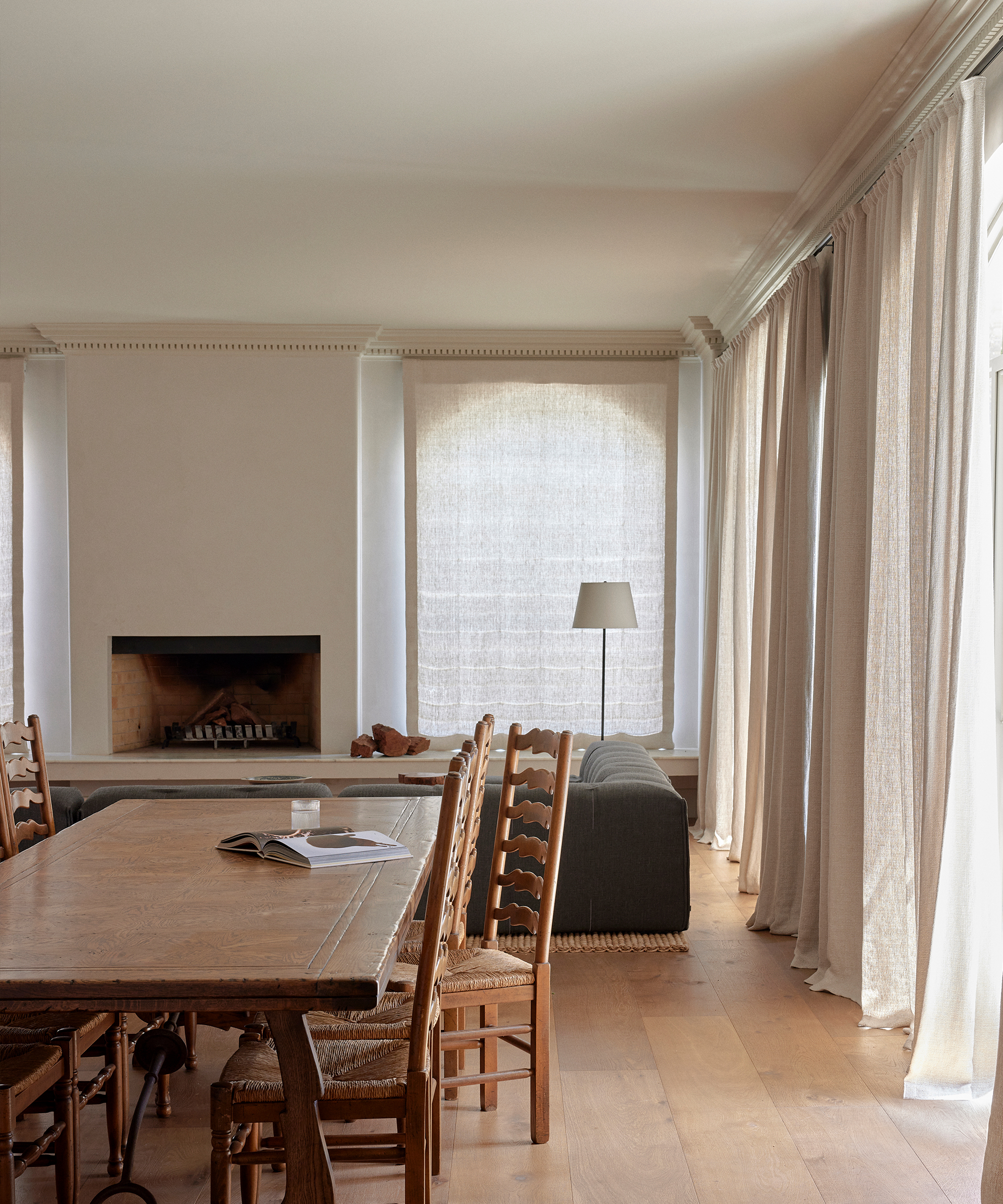 emily-gillis-home-tour-living-room-dining-area-wood-dining-chairs