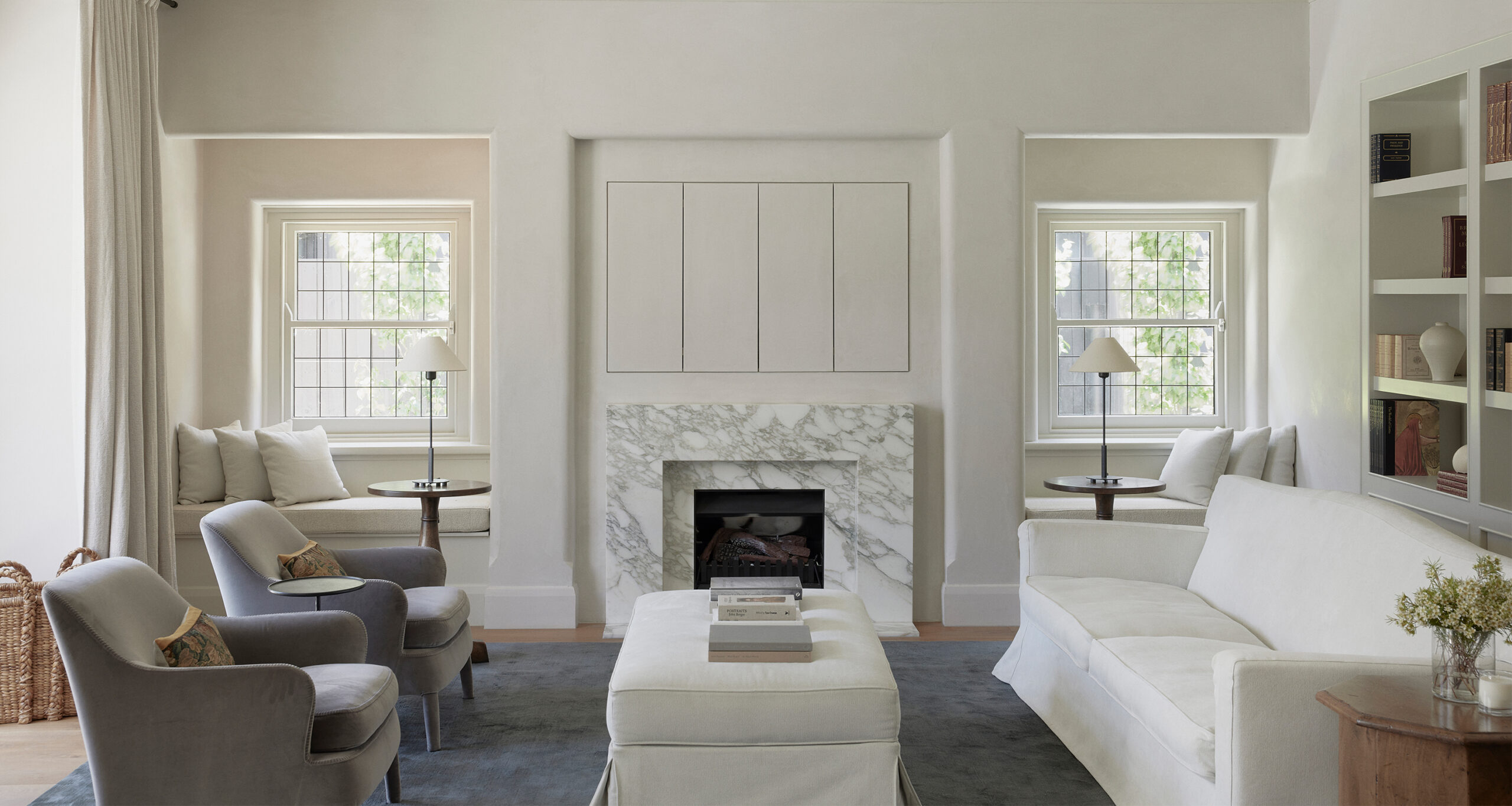 emily-gillis-home-tour-living-room-white-couch-slipcovered-ottoman