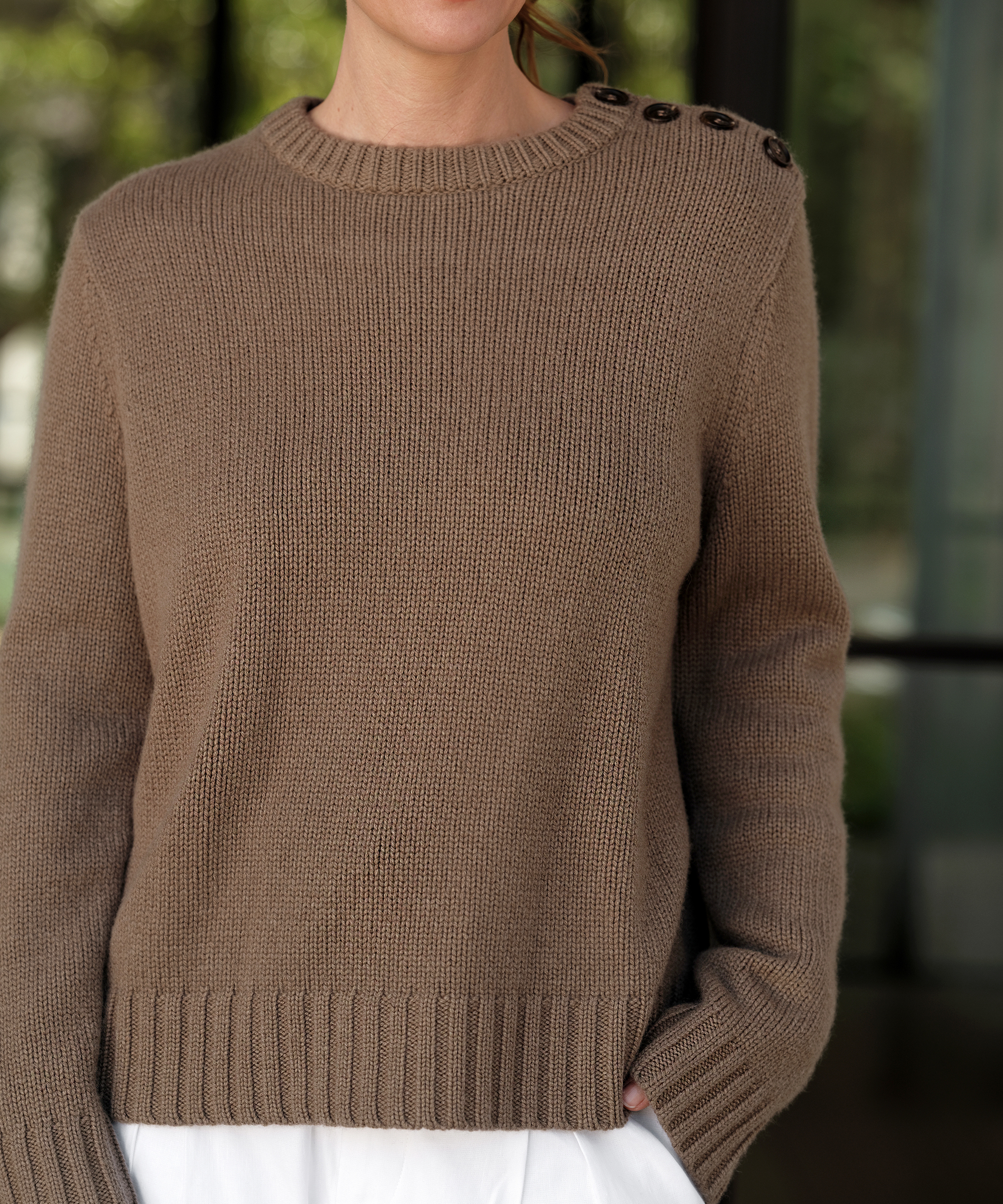 a taupe crewneck sweater with buttons on the shoulder