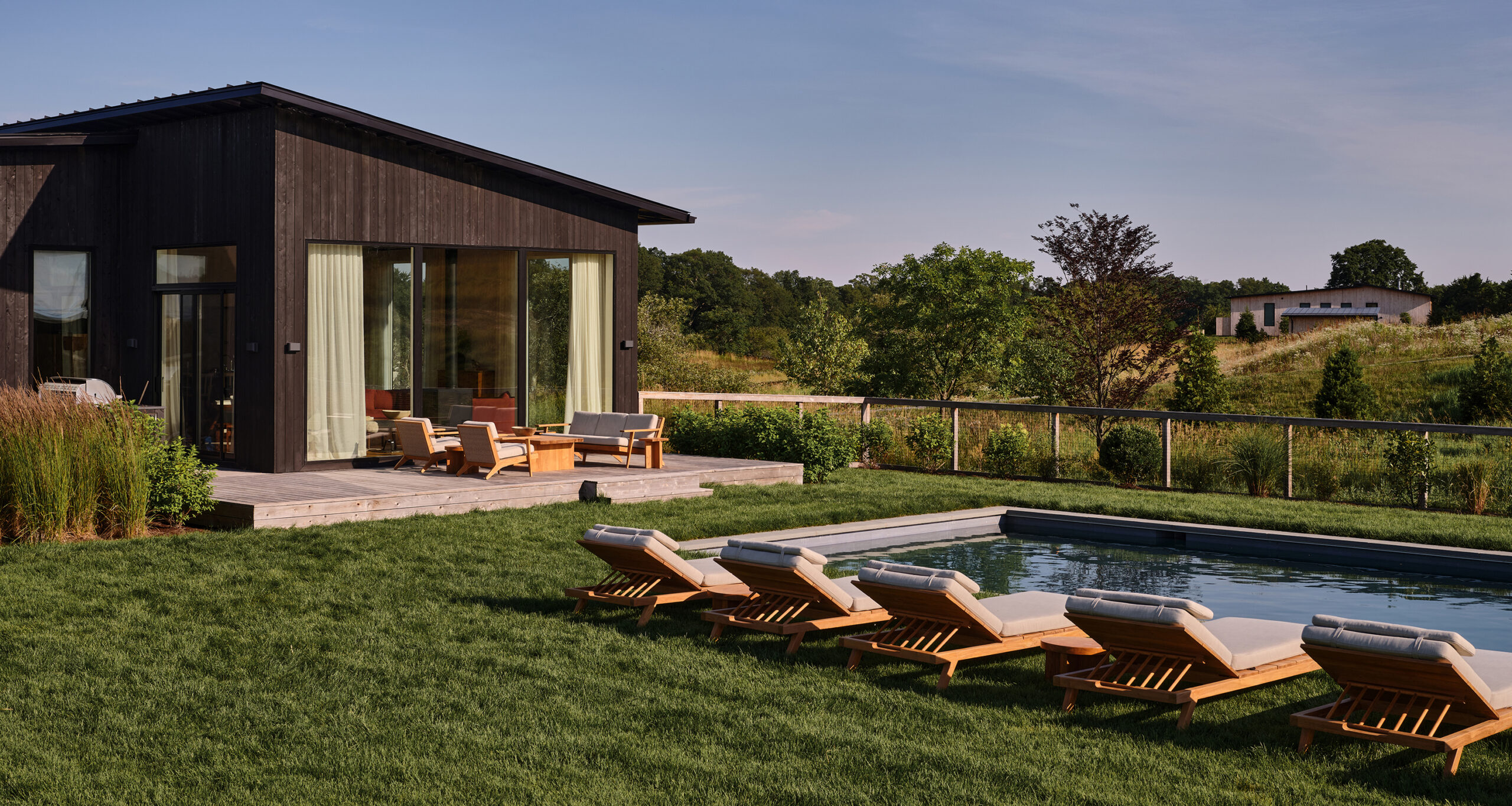 jenni-kayne-farmhouse-backayrd-reveal-porch-and-pool-loungers