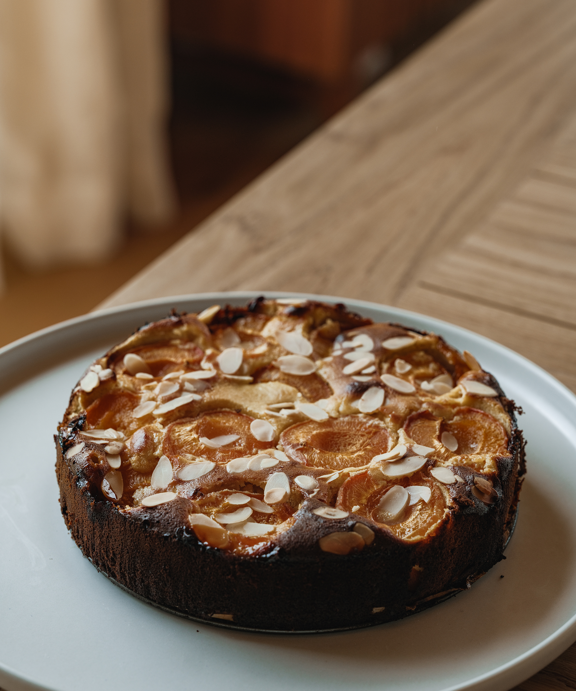 a taupe serving platter with an apricot cake