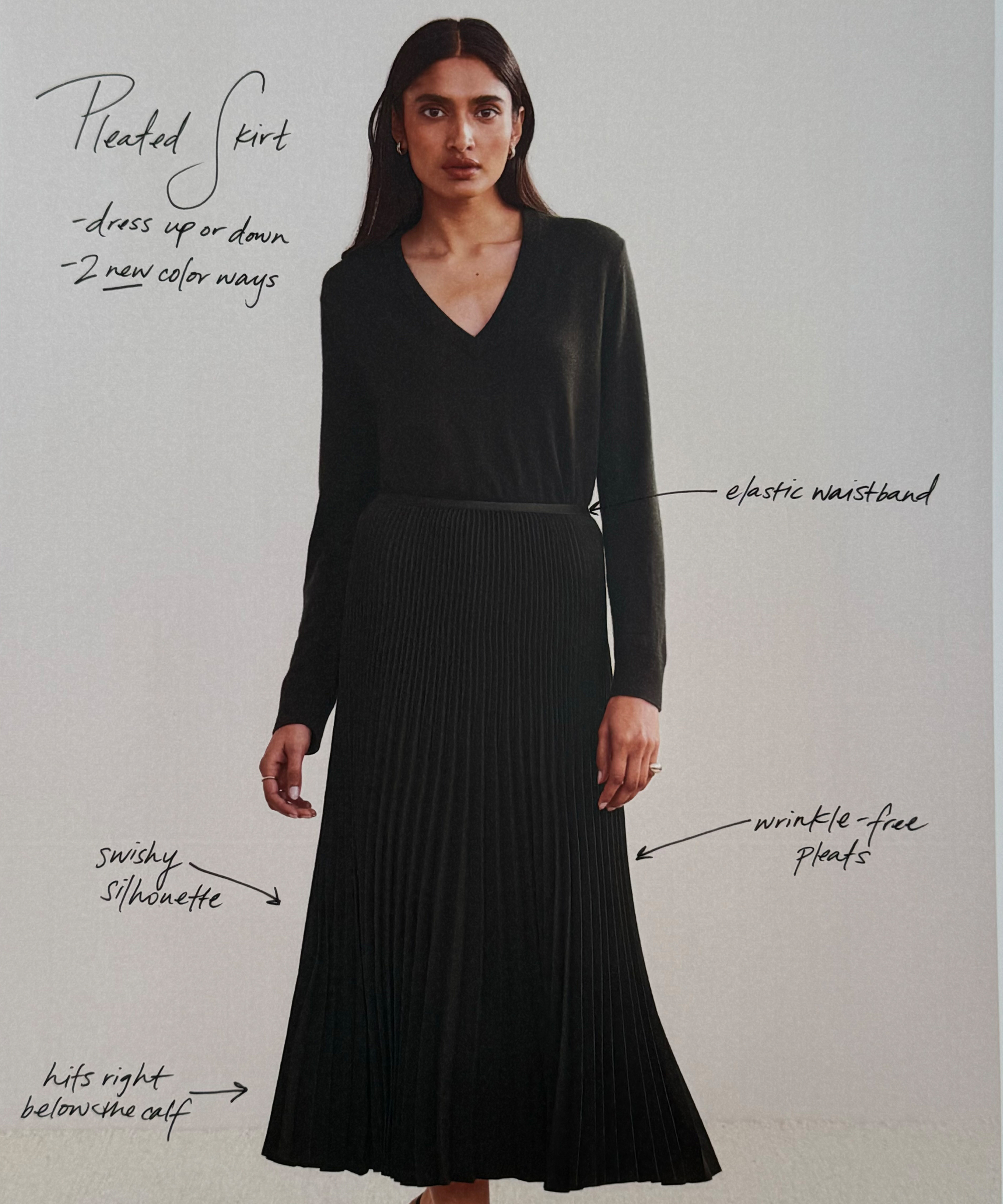 a photo of a model in a black pleated skirt and black vneck sweater with handwriting