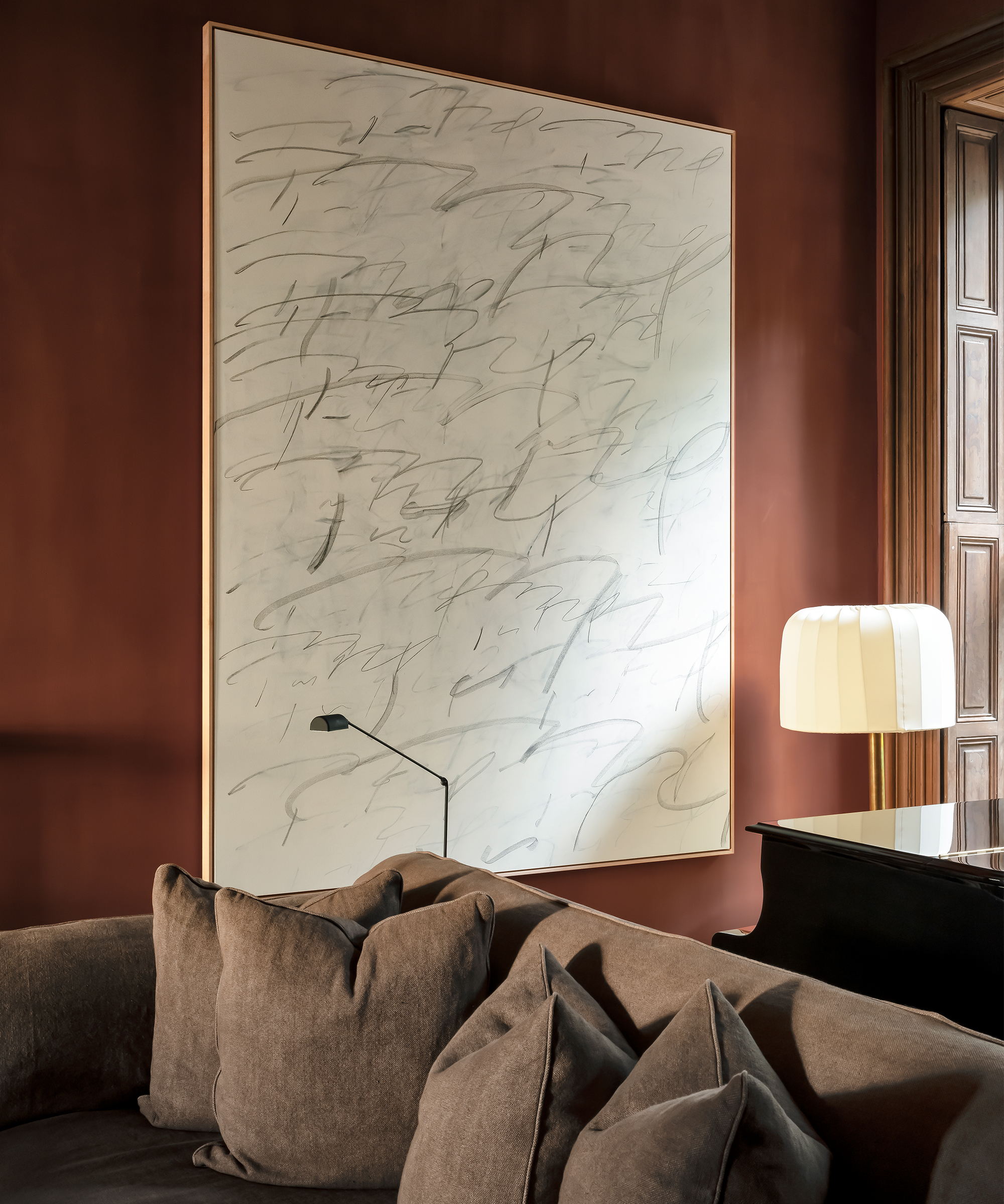 nicolas-schuybroek-home-tour-brown-couch-living-room-painting