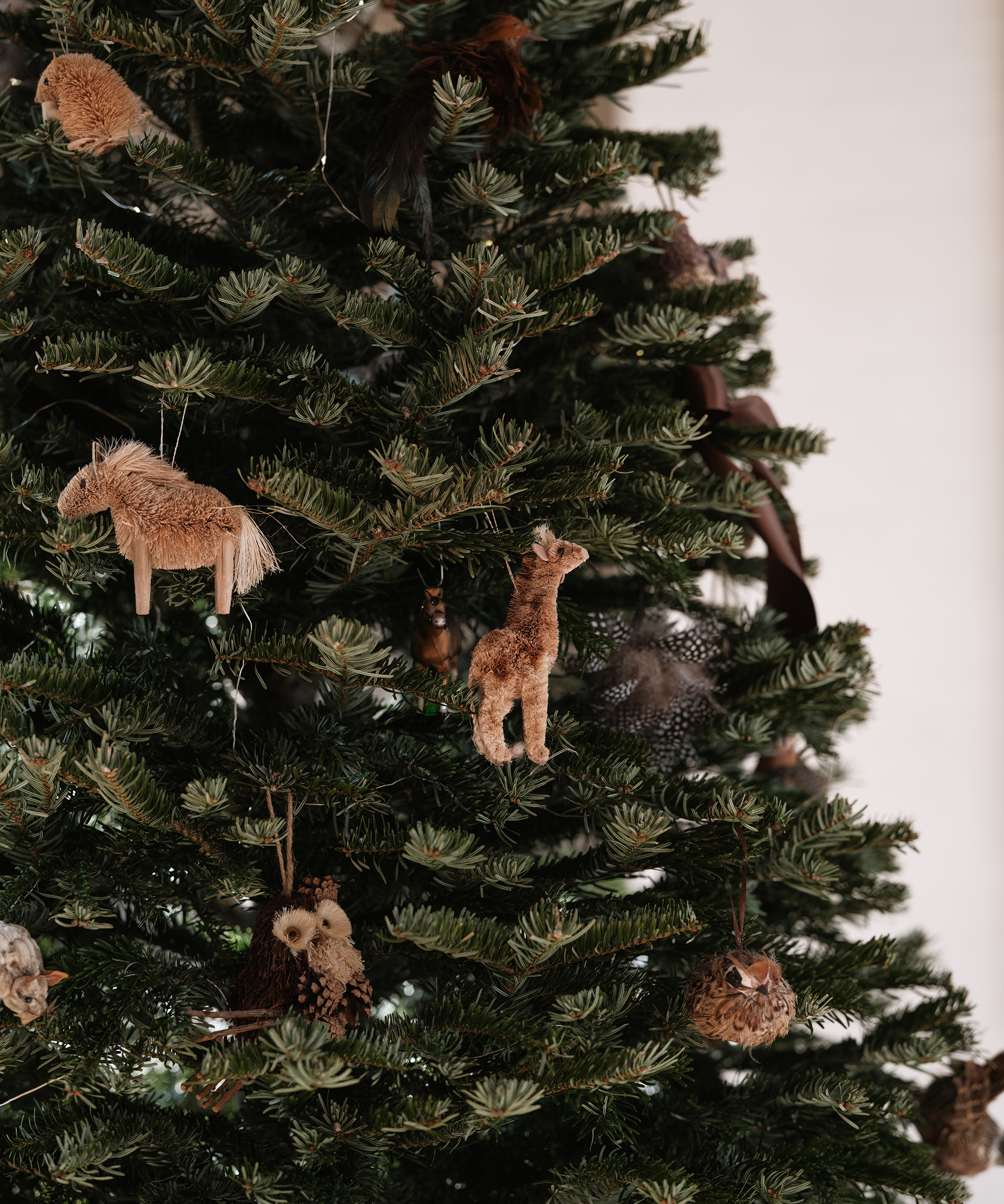 a christmas tree with wooden animal ornaments